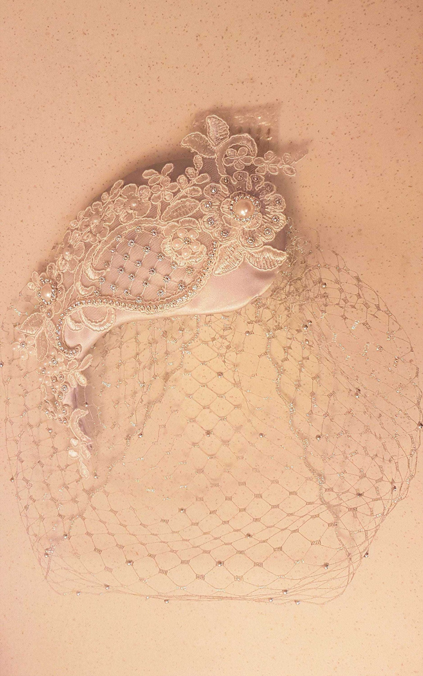 Bridal birdcage veil fascinator with pearls and crystals, vintage 1950s style headpiece.