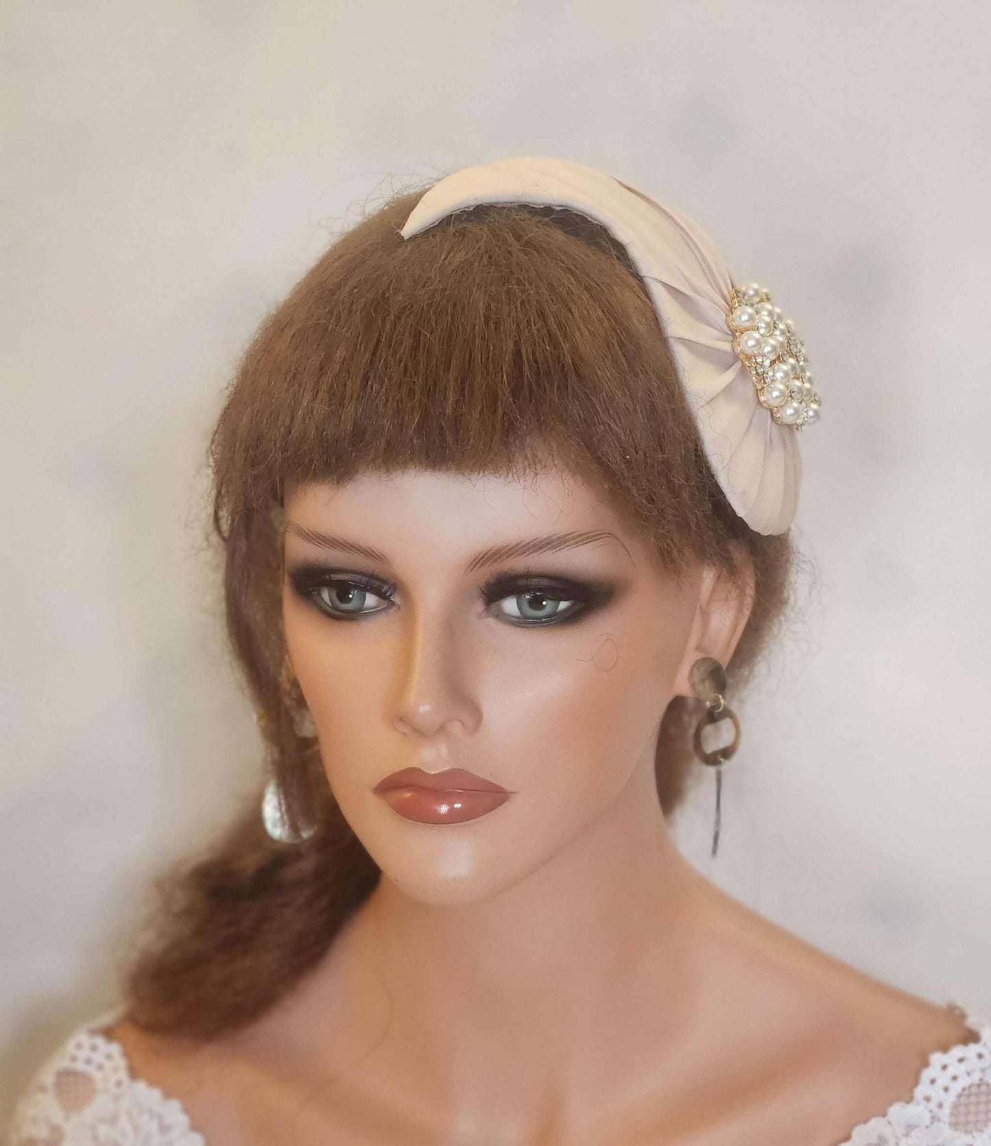 Bridal hat fascinator with birdcage veil, featuring pearls and crystals, perfect wedding hair accessory.