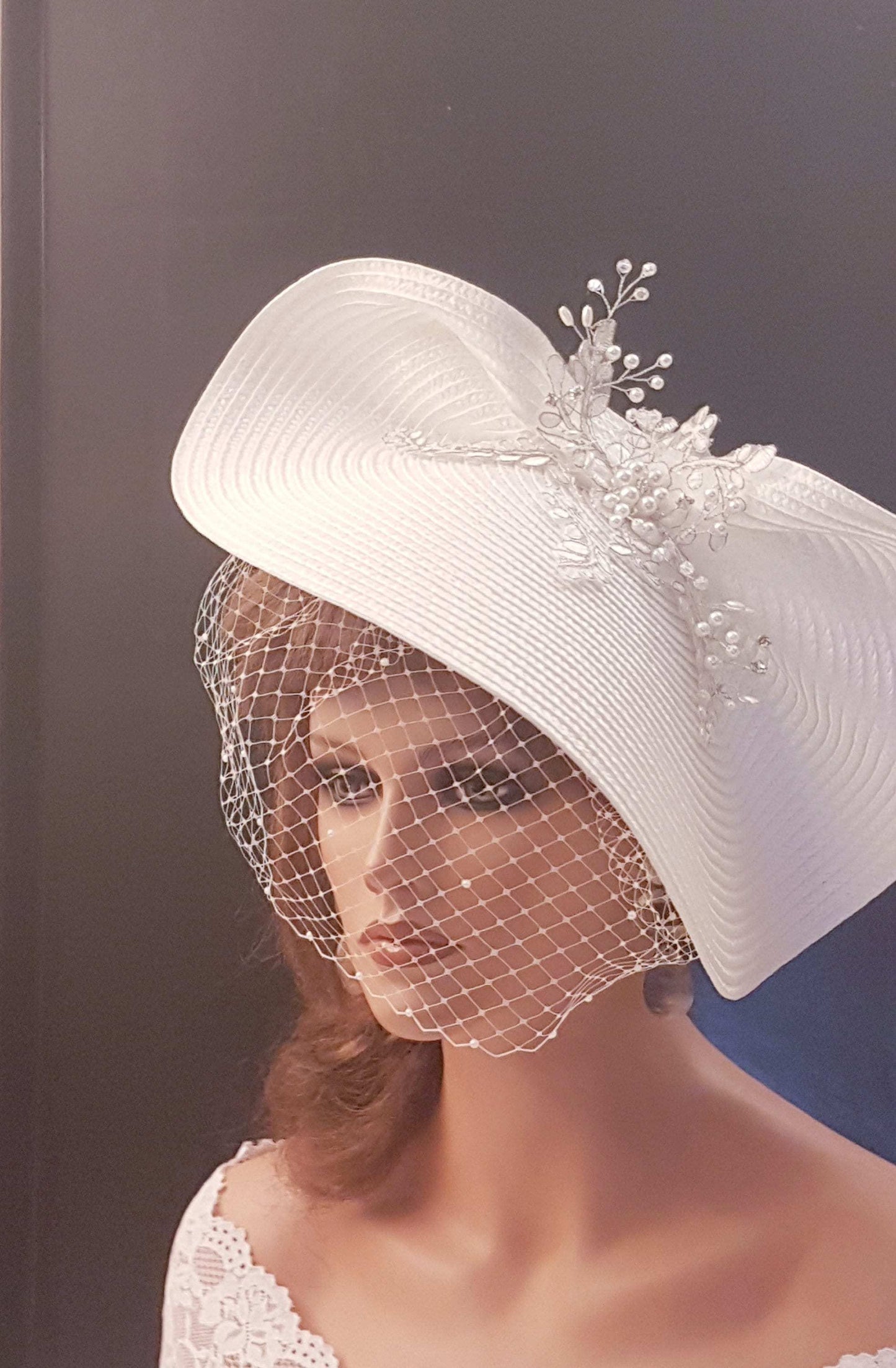 FASCINATOR with veil White Modern Bridal wedding headdress with Birdcage Veil. Adorned with stunning Silver thread Motif and with gently floating Pearls and crystals