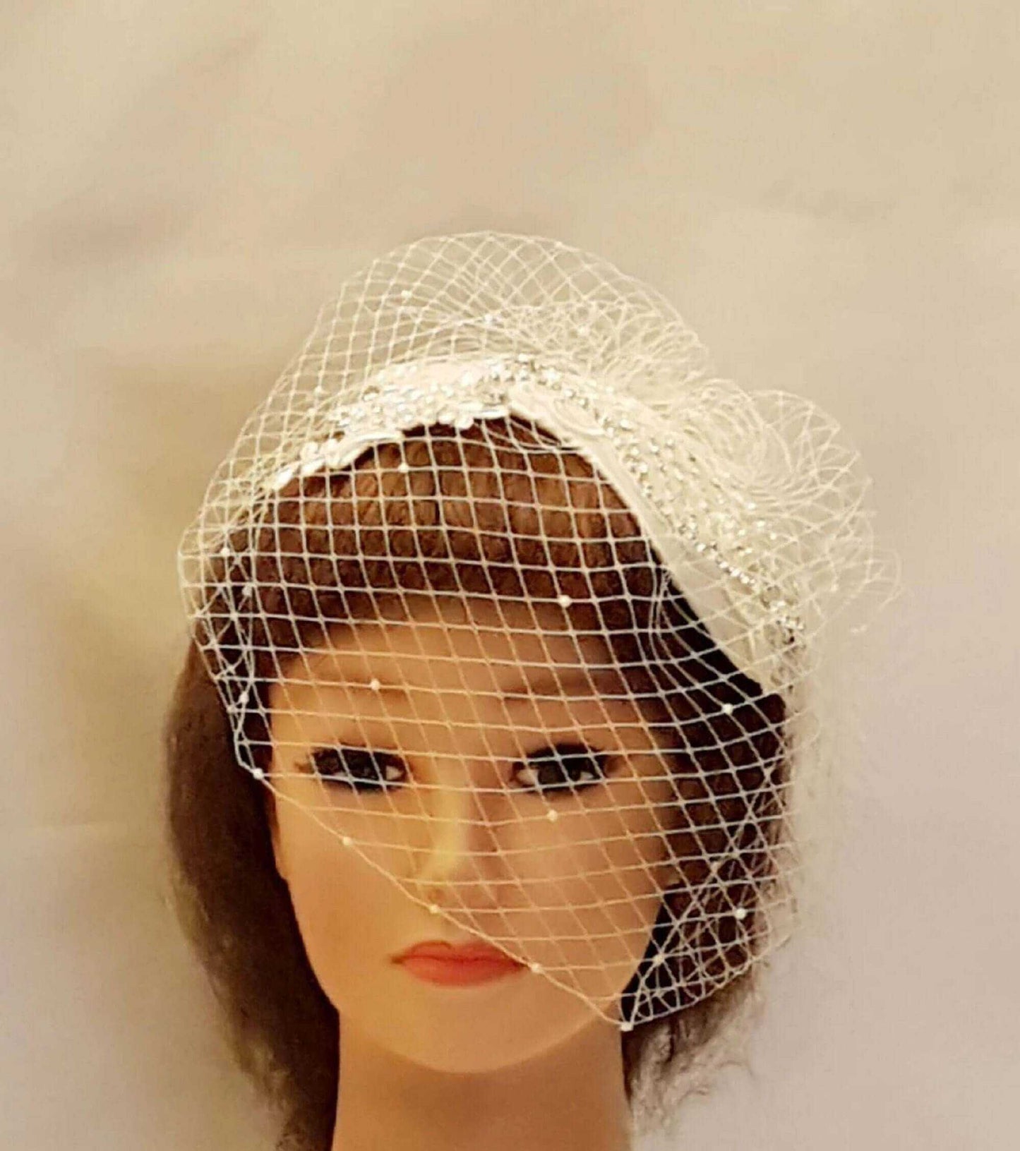 Bridal fascinator with birdcage veil birdcage veil on mannequin head, vintage style.