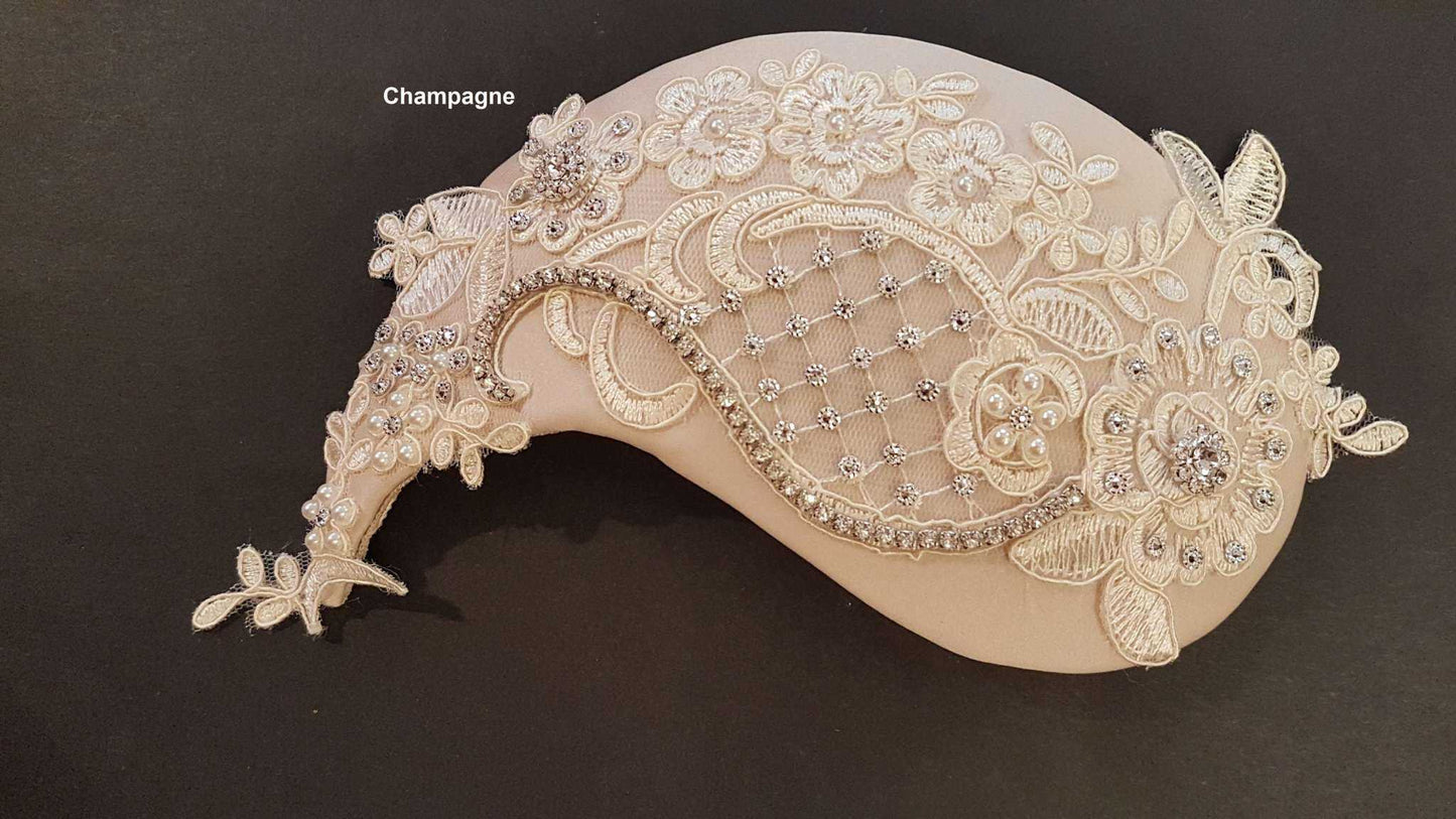 Bridal fascinator with birdcage veil in champagne color adorned with crystals and lace.