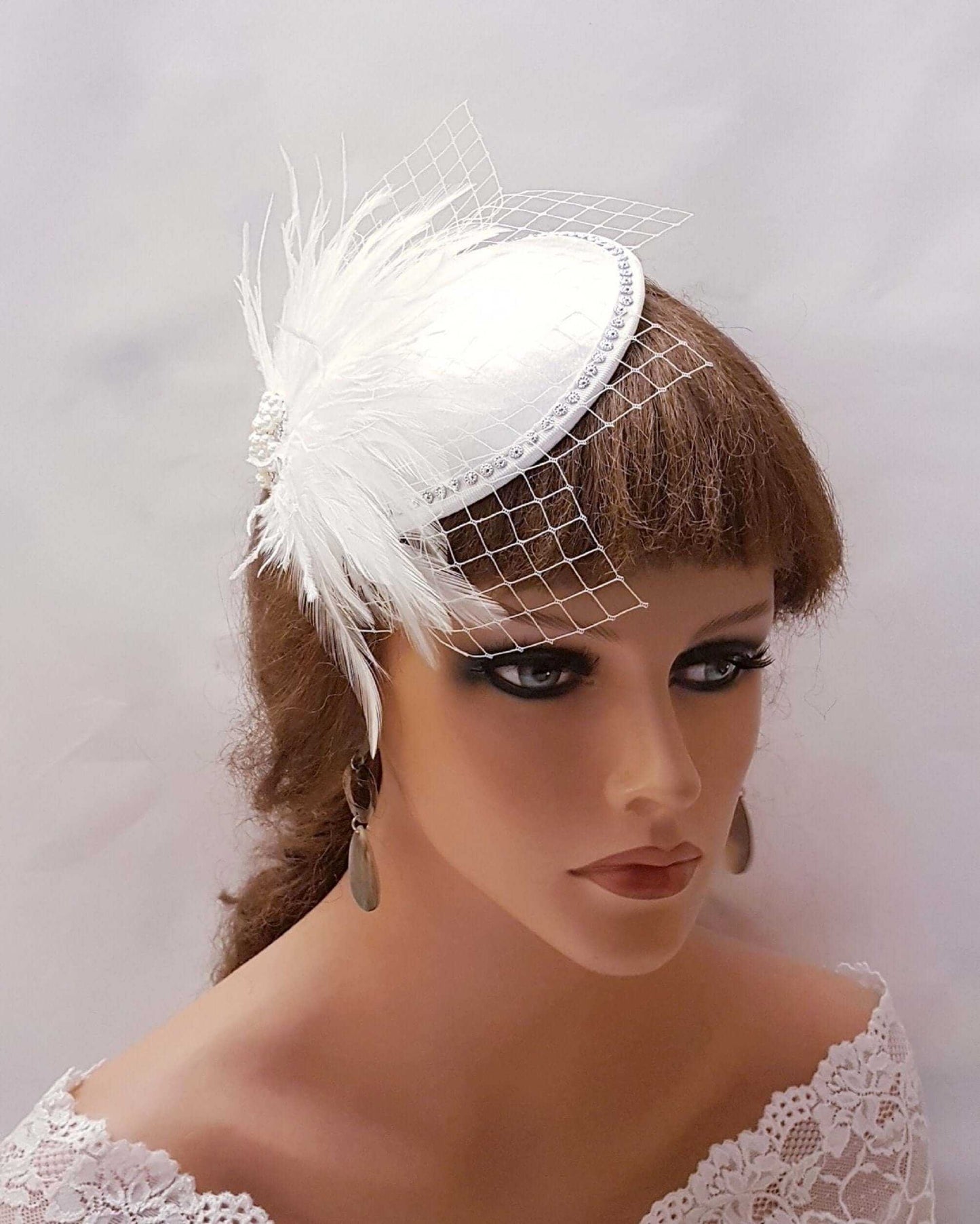 White Ivory bridal feather hat fascinator with French netting and crystal detailing, wedding hair accessory.