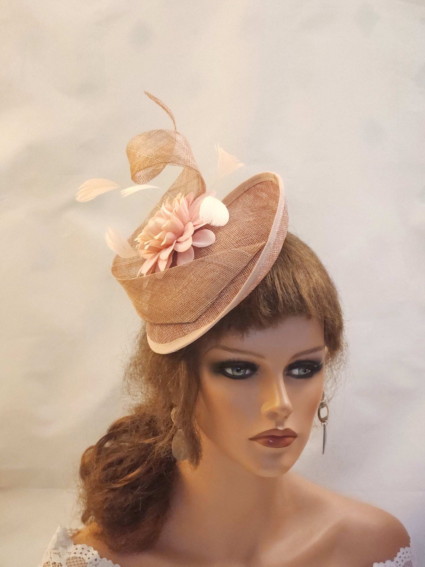 Dusty peachy pink sinamay fascinator hat with flower and swirl detail, perfect for weddings, ascot, cocktail parties, and church events