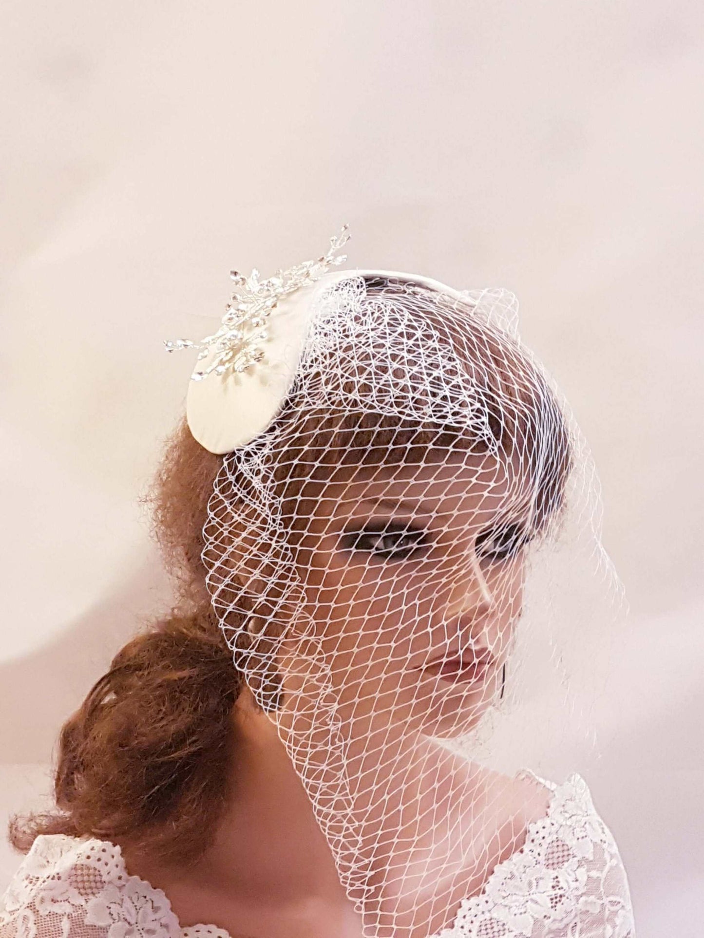 Bridal birdcage veil with vintage fascinator and crystal embellishments in white and ivory
