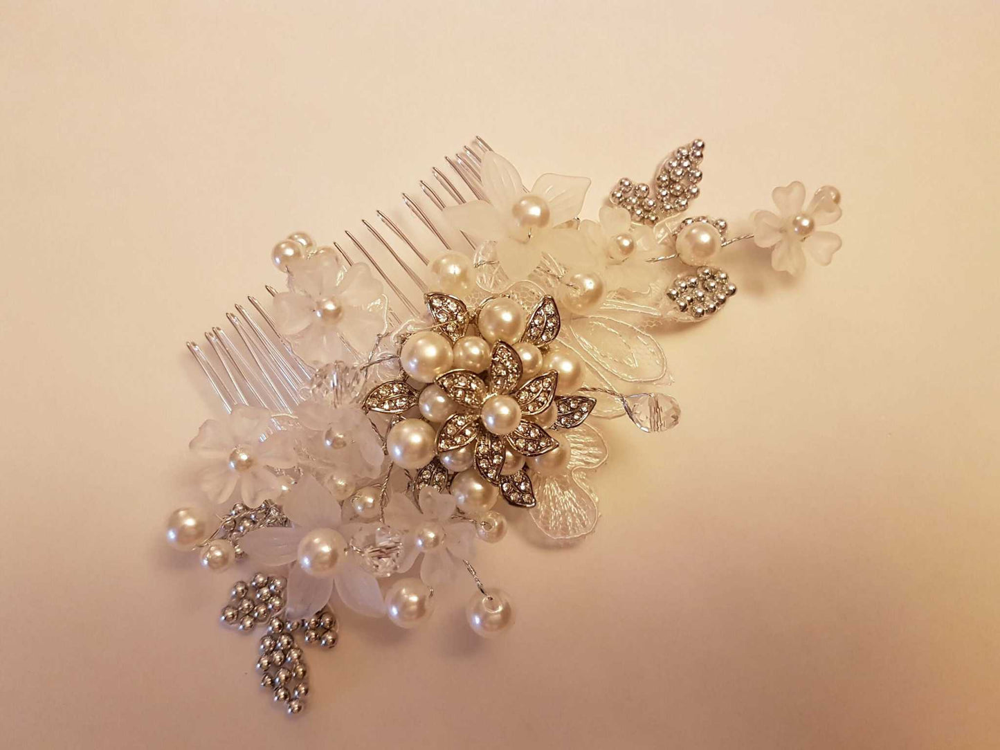 Bridal birdcage veil with detachable floral lace comb adorned with pearls and crystals.