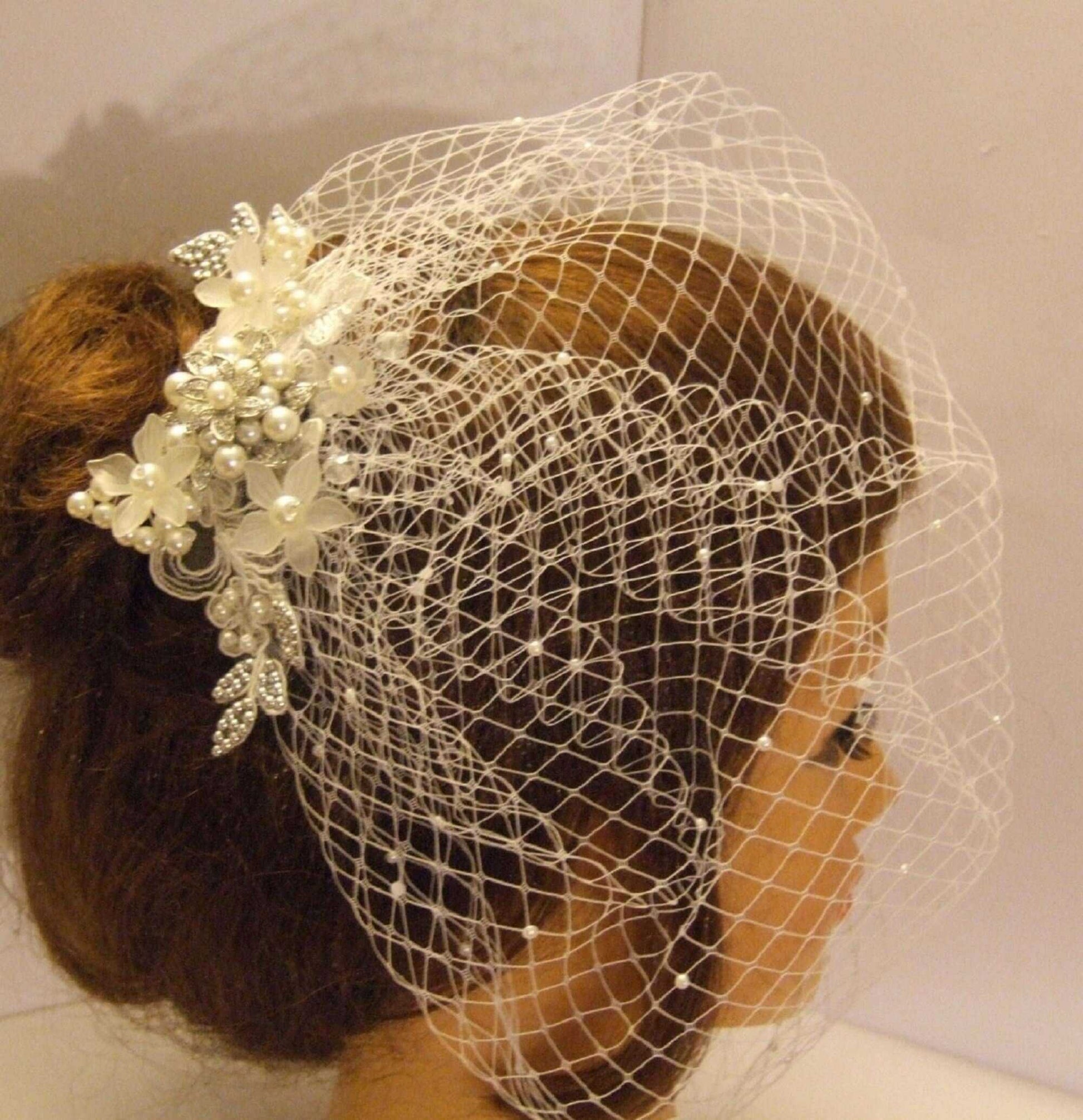 Bridal birdcage veil with lace and pearl fascinator.