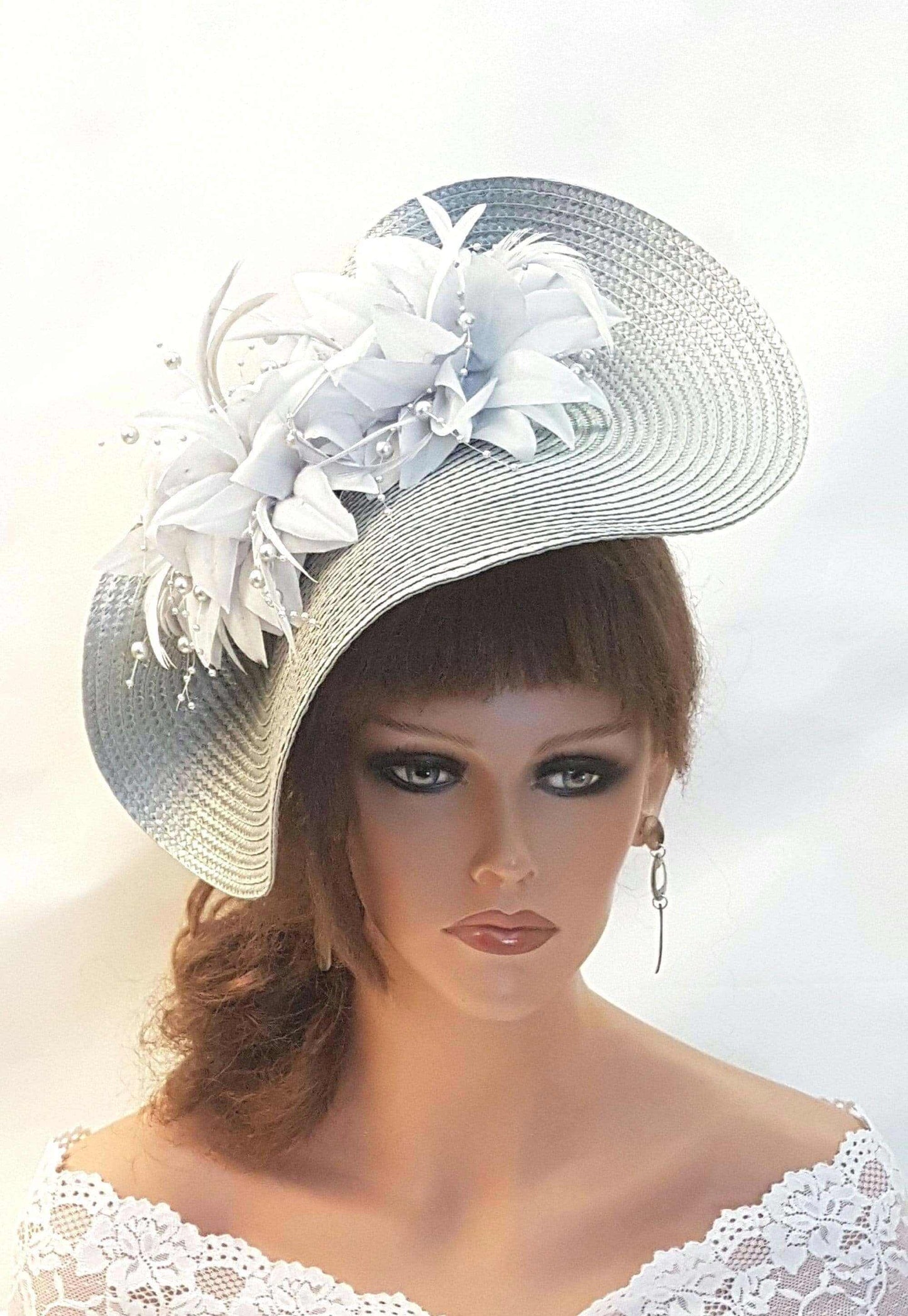 Elegant silver grey fascinator with quill feather and silk flowers, ideal for weddings and races. I