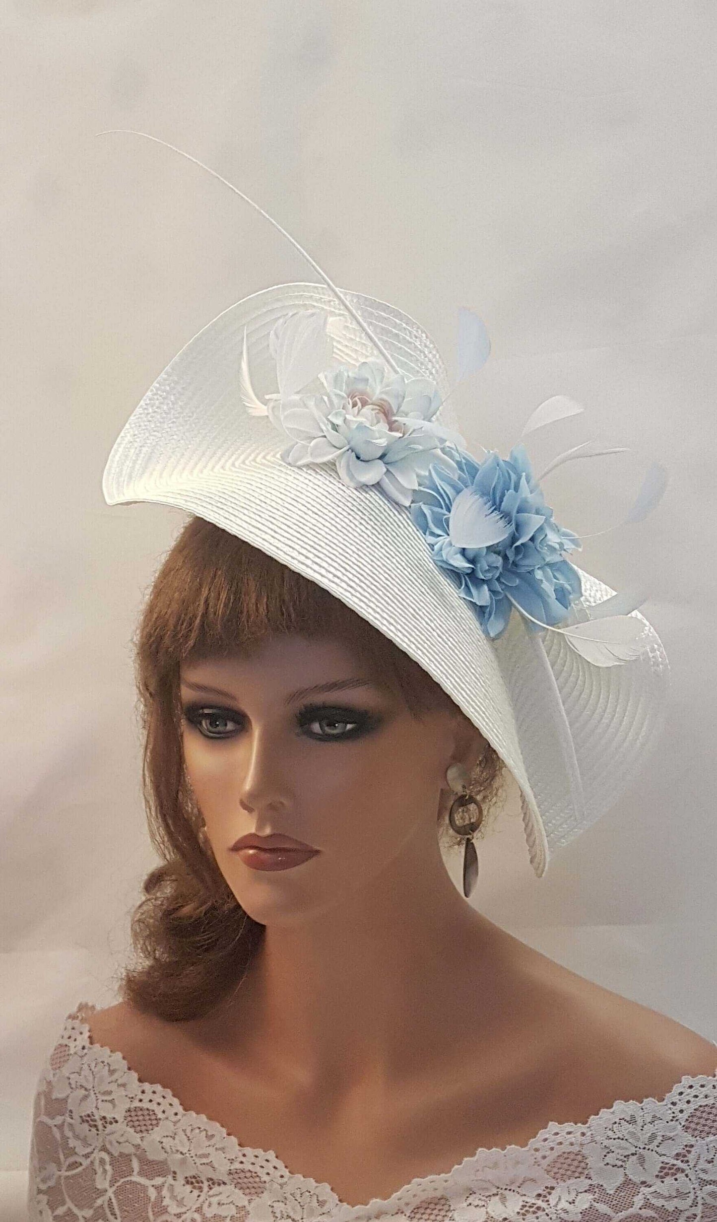 White and blue wedding fascinator saucer hat with quill feather and floral accents for Mother of Bride and special occasions