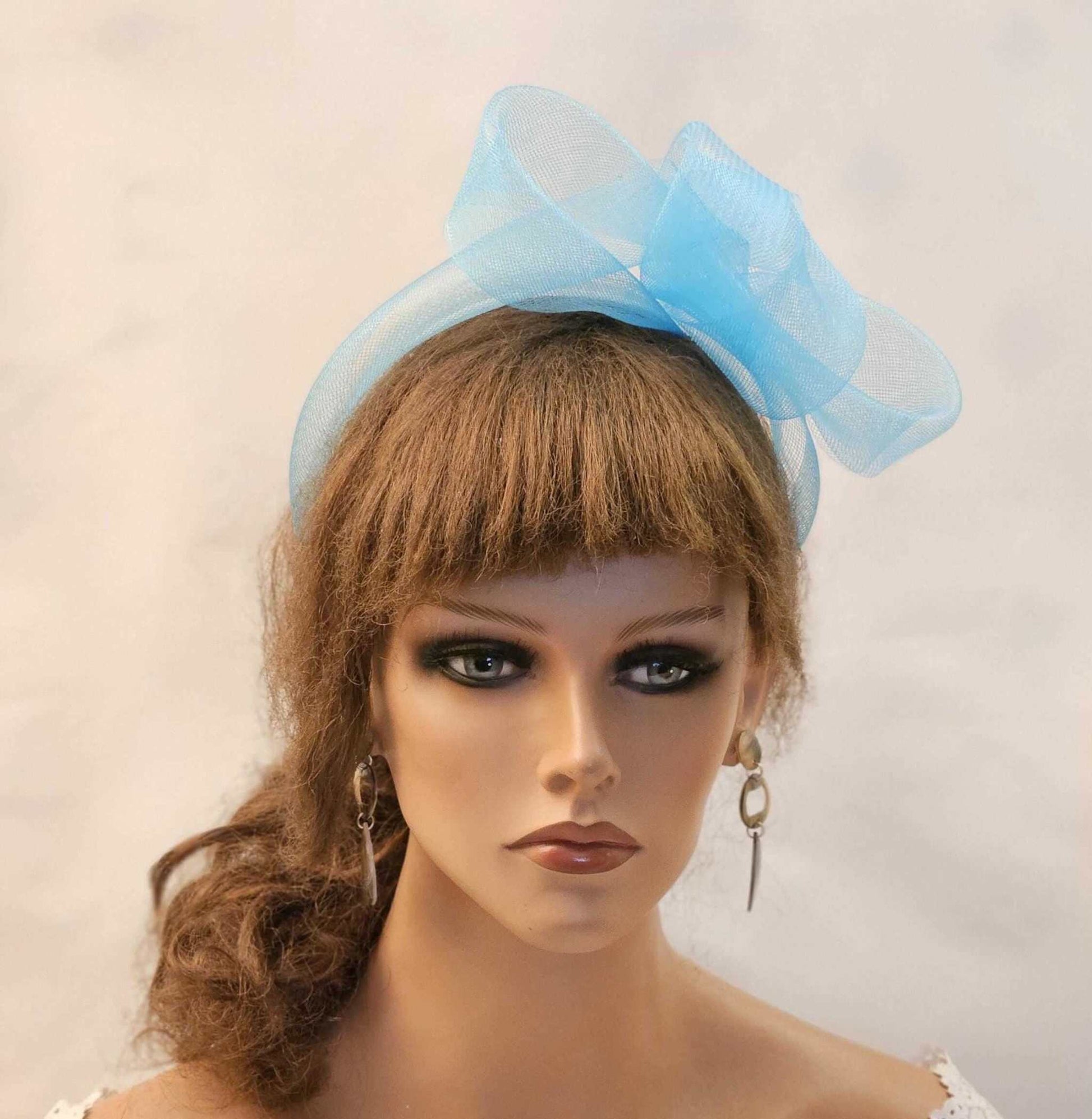 Blue bow and knot headband fascinator for weddings and events.