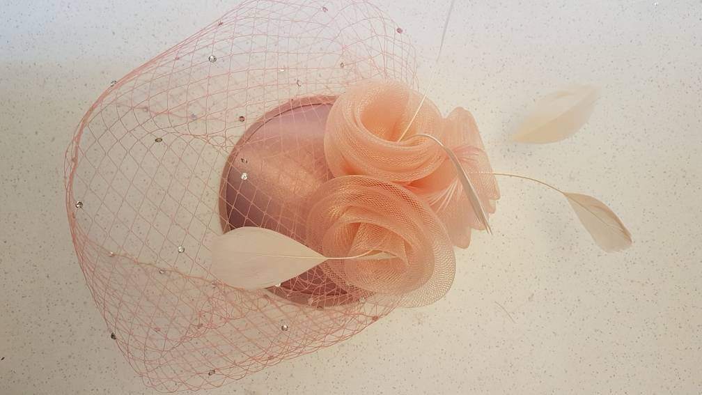 Bridal birdcage veil hat fascinator with crinoline roses and feathers in white, ivory, or black.