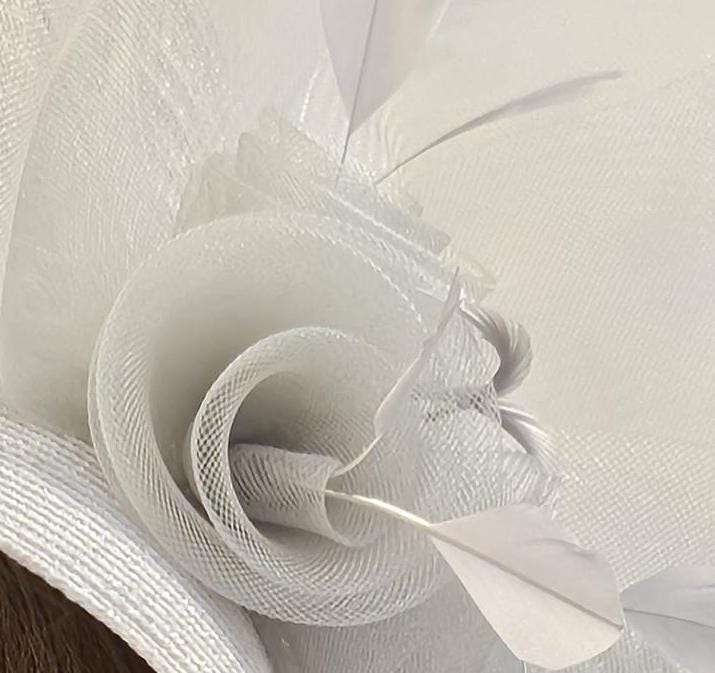 Bridal birdcage veil hat fascinator with crinoline roses and feather detail in white.