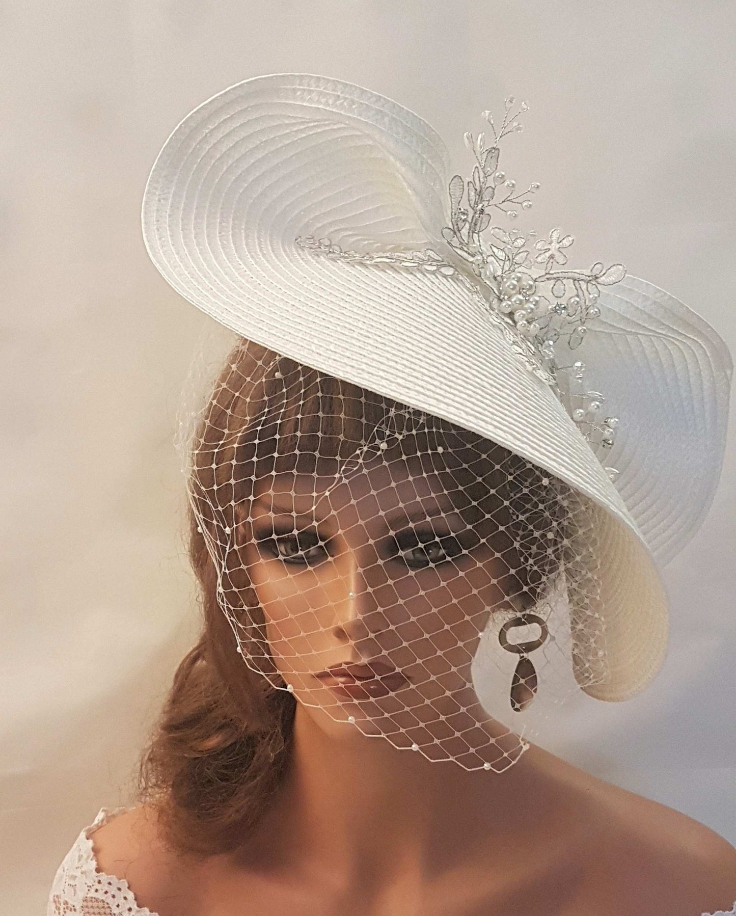 FASCINATOR with veil White Modern Bridal wedding headdress with Birdcage Veil. Adorned with stunning Silver thread Motif and with gently floating Pearls and crystals