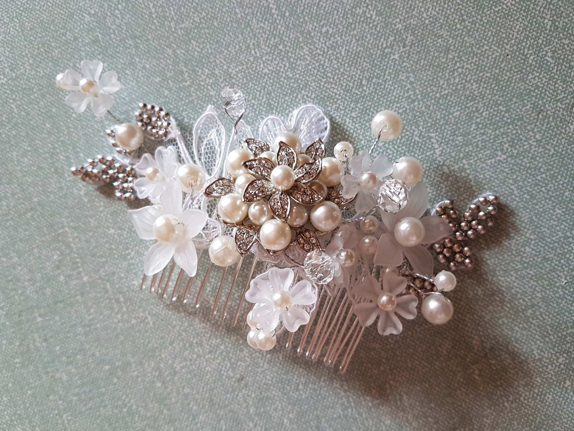 Bridal birdcage veil with pearl and crystal floral headpiece, wedding hair accessory with lace and beaded details.