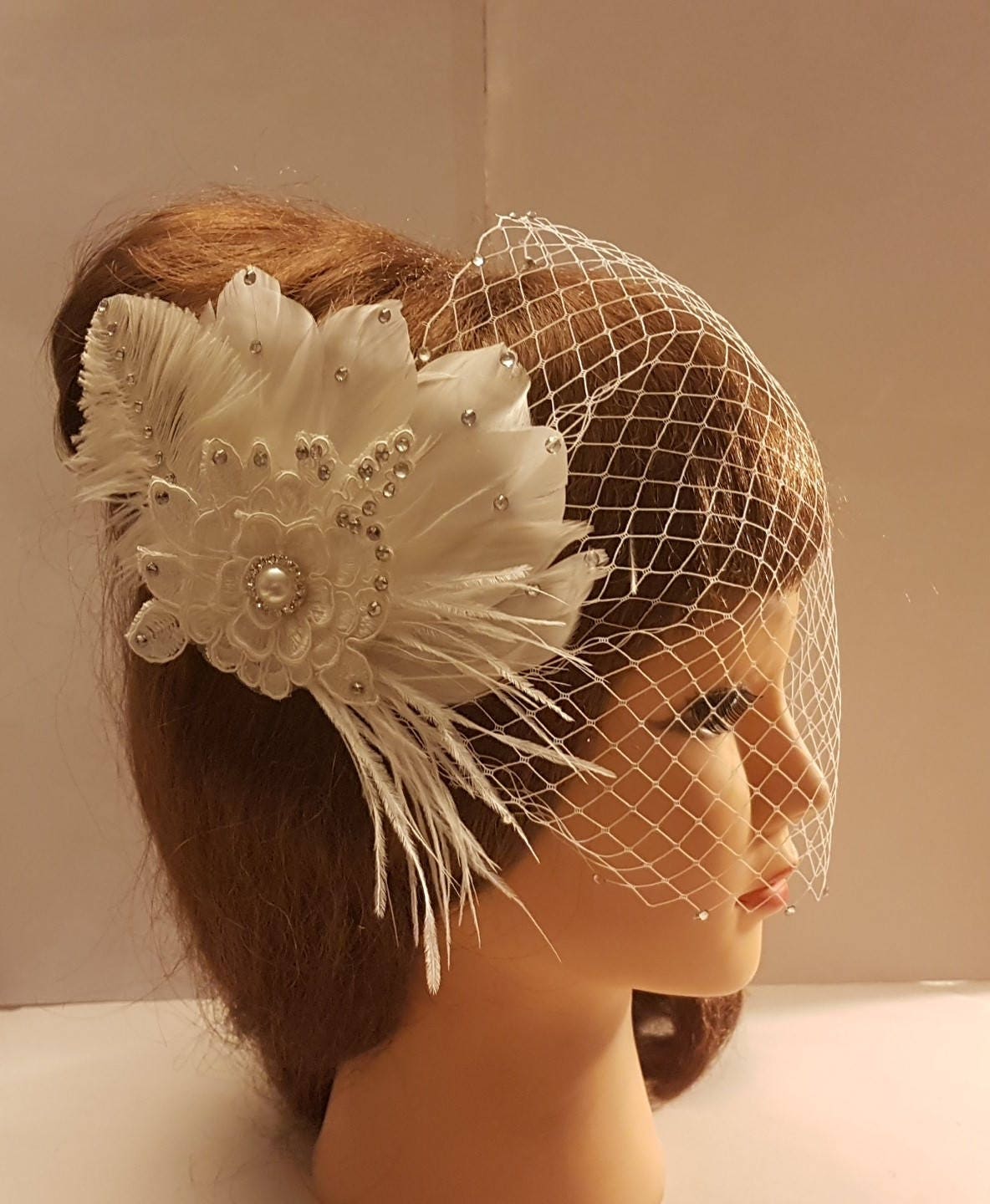 bridal veil with feather and flower embellishment.