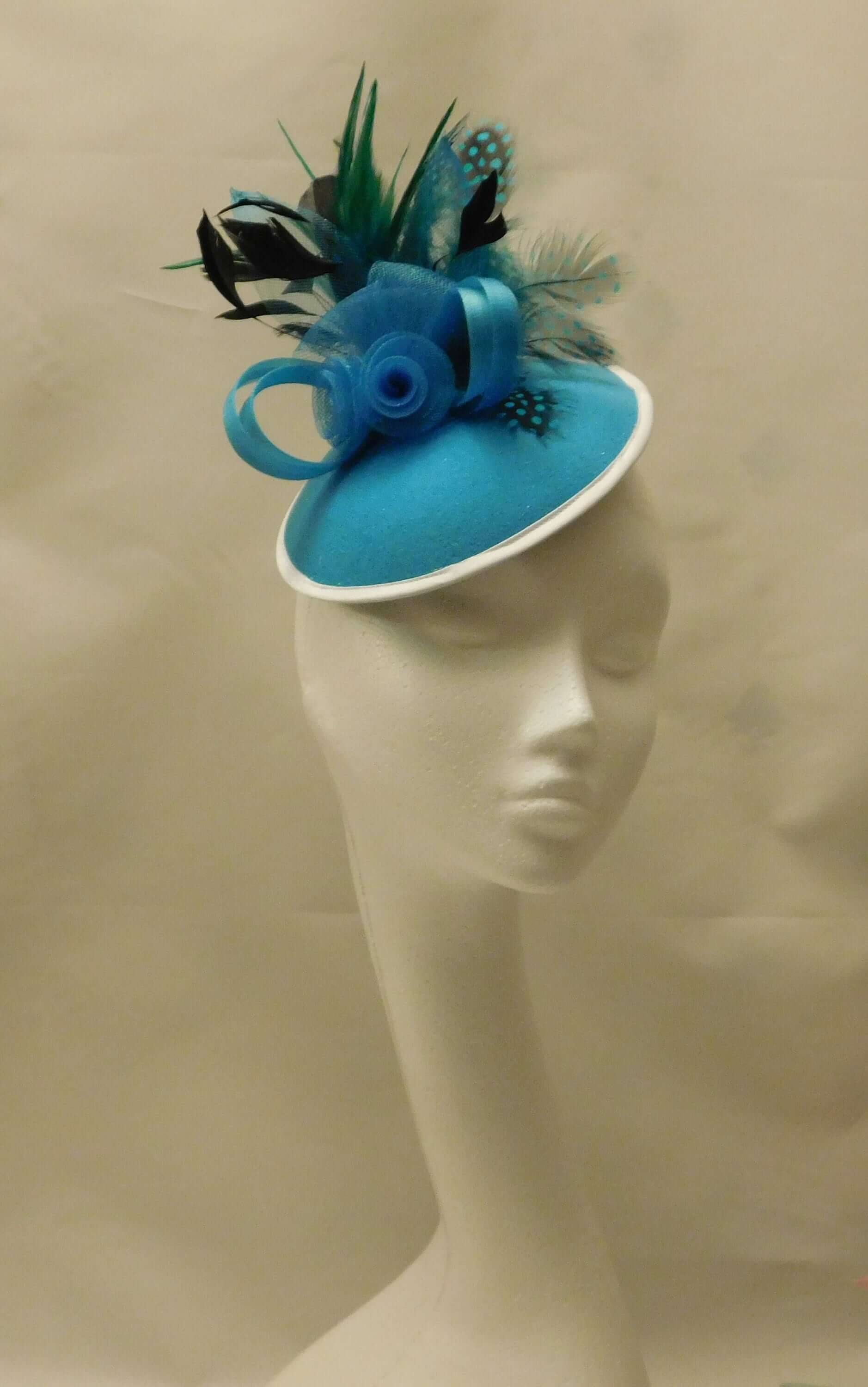 Blue Feather Fascinator dorned with crinoline Roses