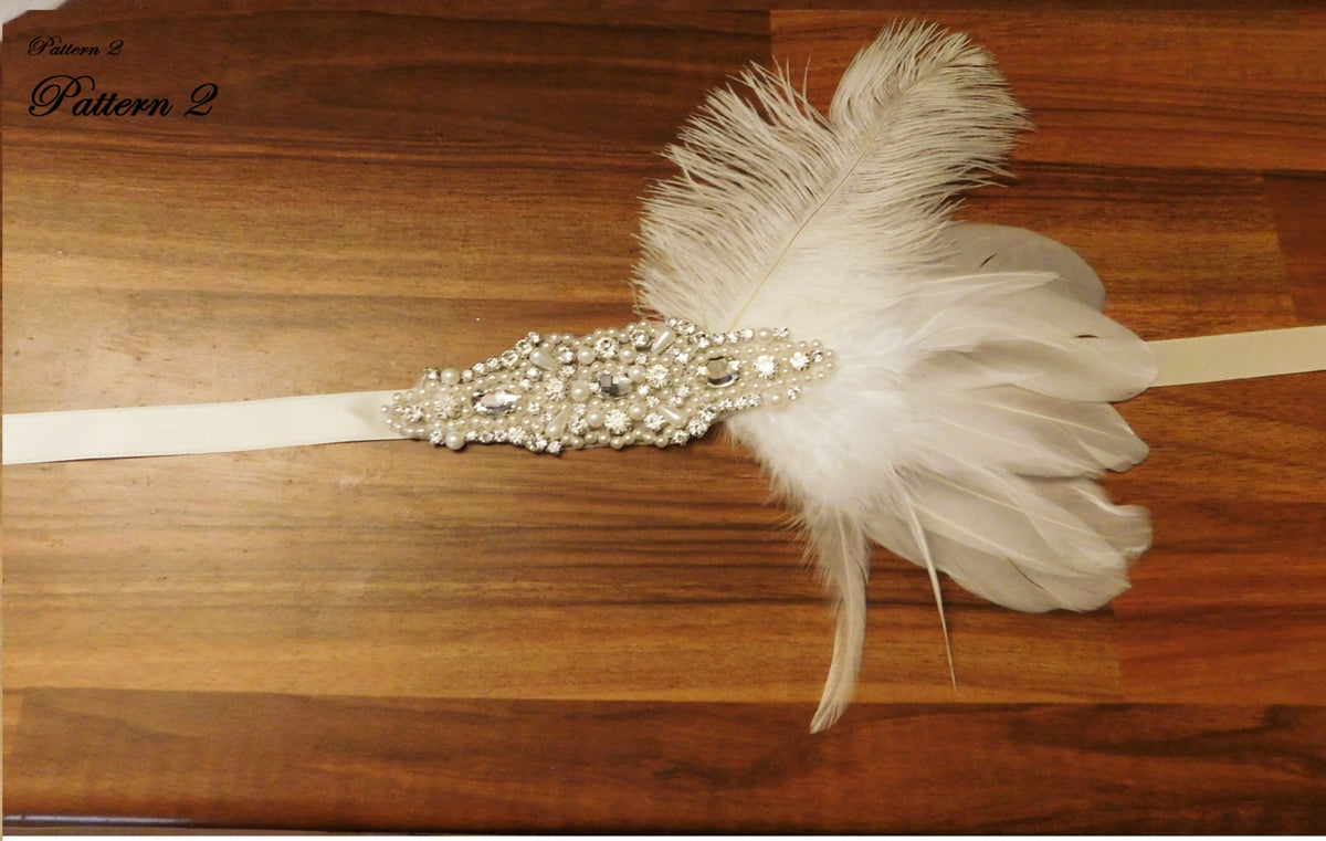 Gatsby feather headband with a silver and pearl embellishment.