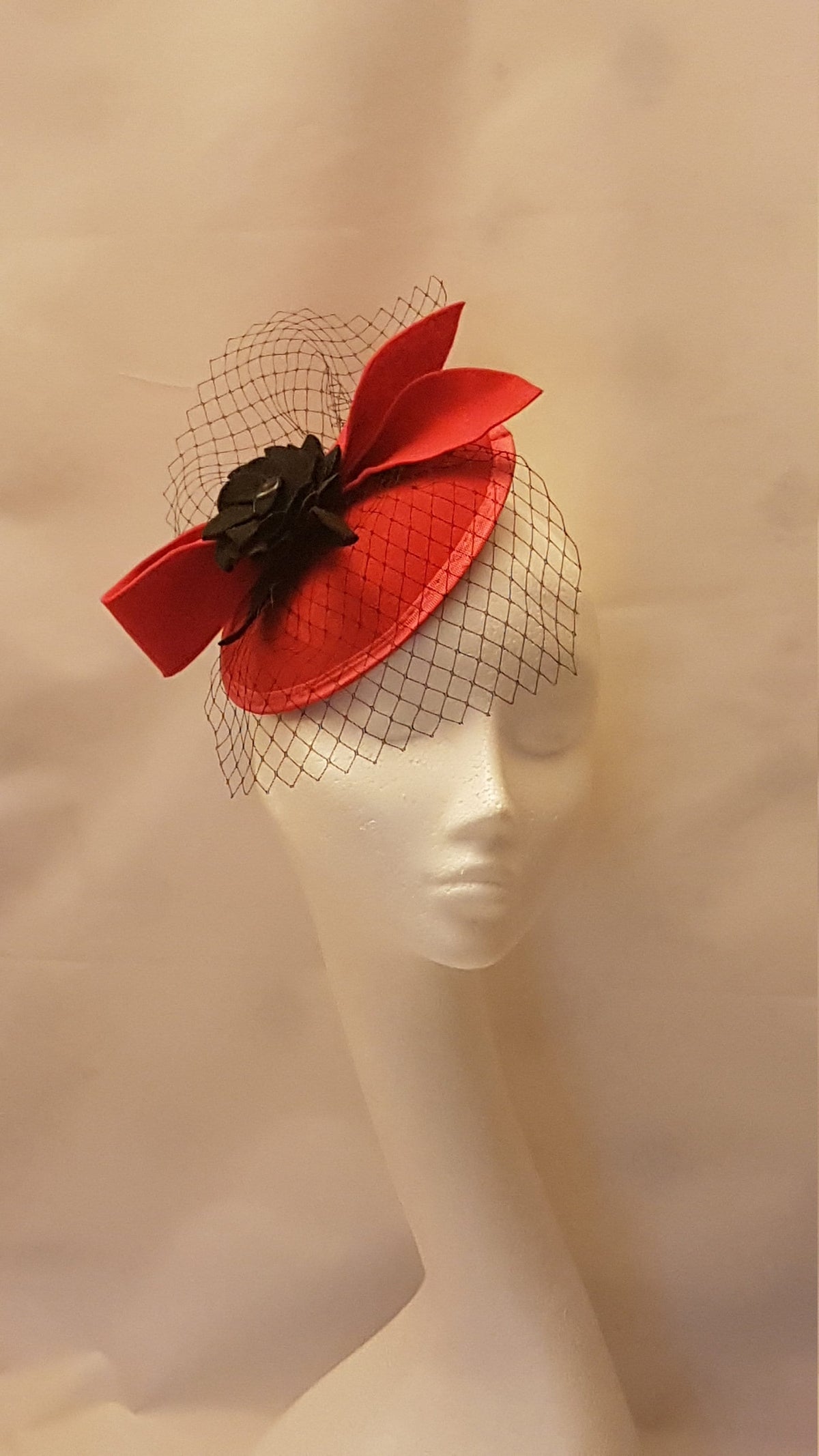 Re.d red felt hat. fascinator  with a black felt flower and a black net veil for Wedding, Party and Ascot