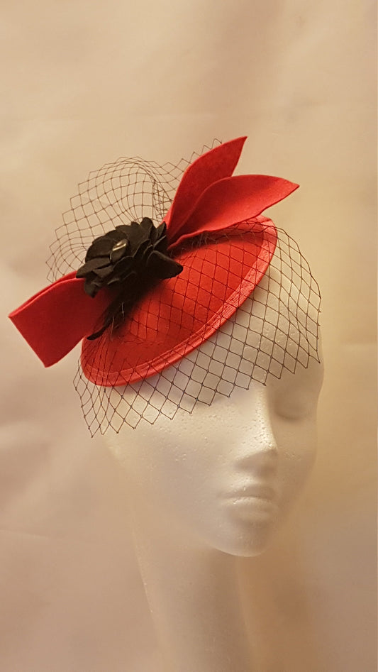 red felt hat with a black felt flower and a black net veil Cocktail party fascinator