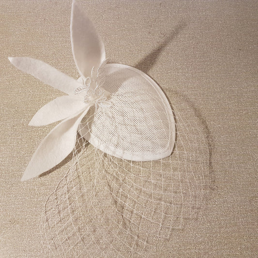 white bridal fascinator hat with a white felt leaves and lace detail design. bridal mini with mini Birdcage veil