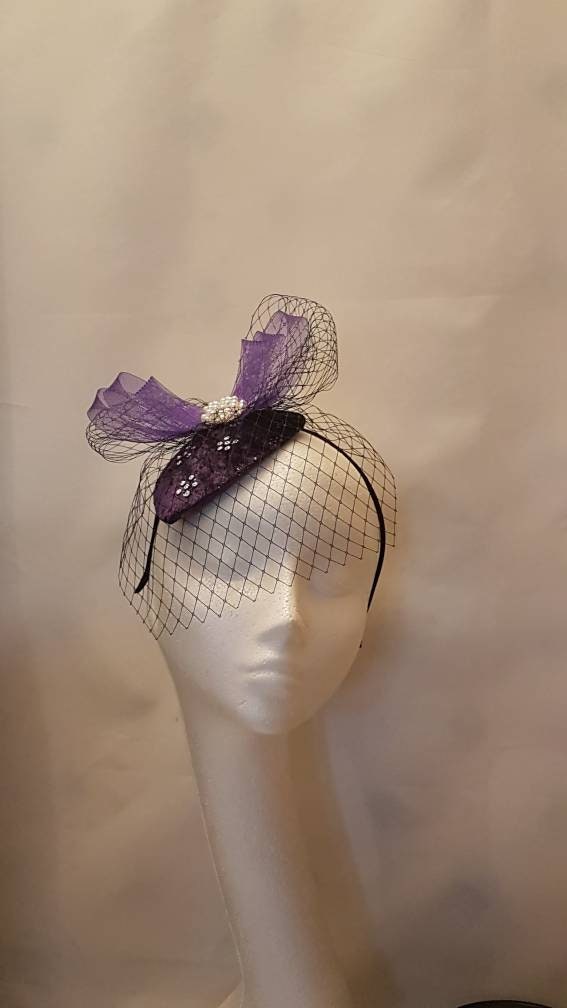purple fascinator with a veil