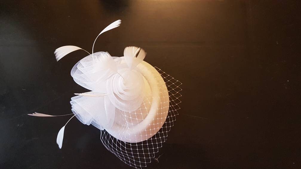 White bridal fascinator with mini birdcage veil