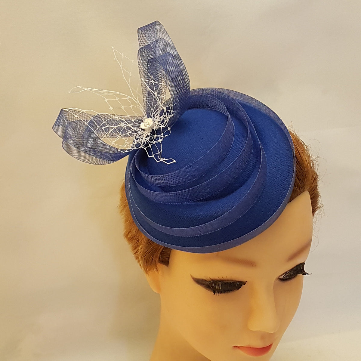 blue felt hat with a white mesh and blue ribbon bow.