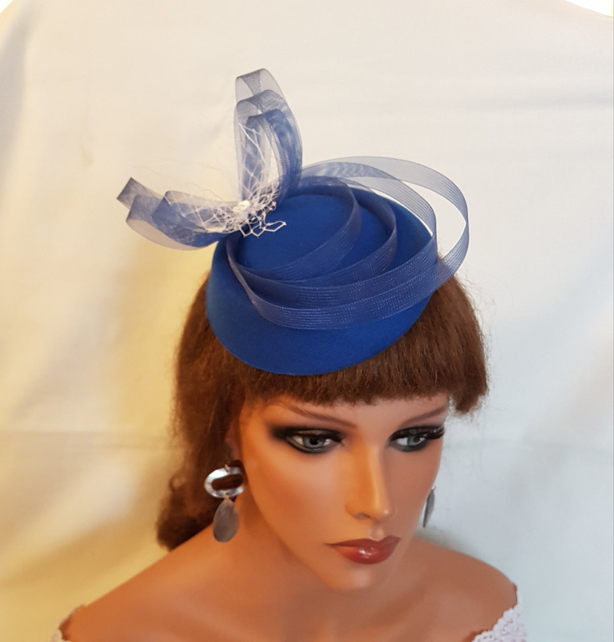 A blue felt hat fascinator