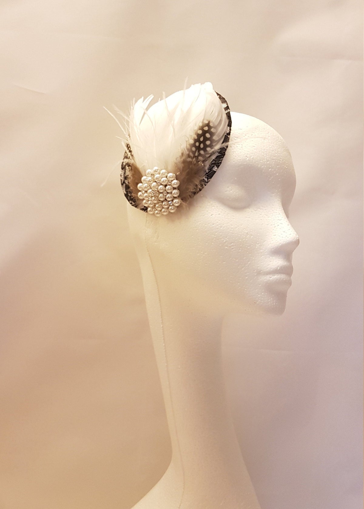Black and white feather and pearl hat fascinator