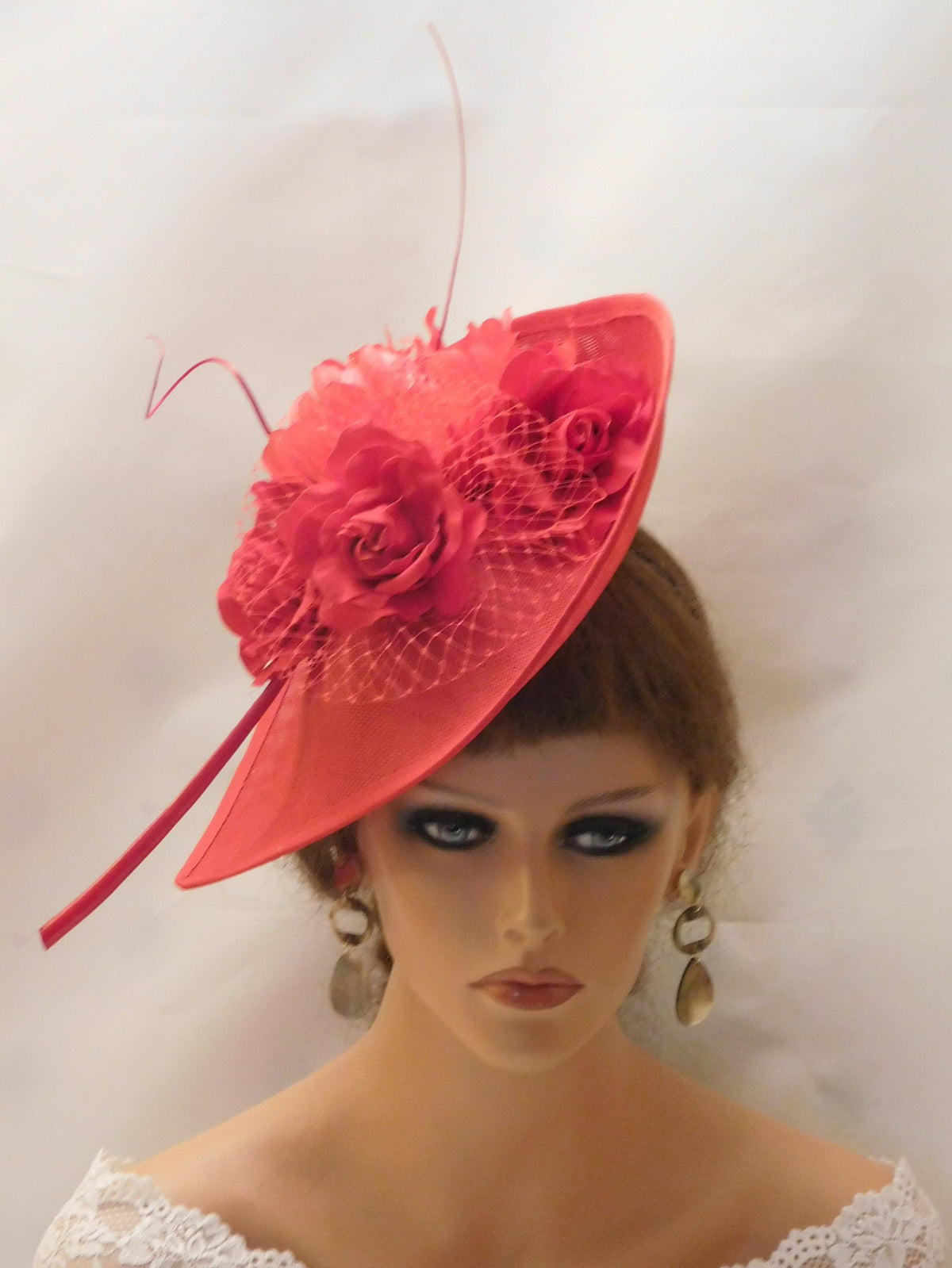 A red hat with a large red flower and a red net.