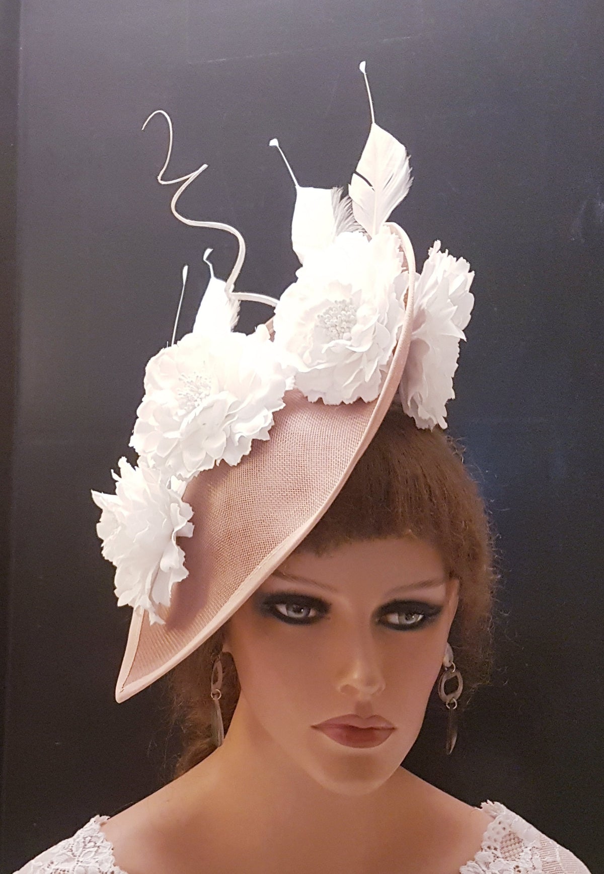 blush pink fascinator with white fabric flowers and feathers.