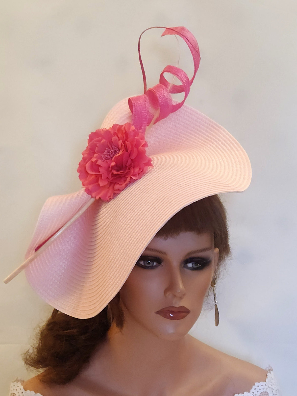 pink straw hat with a pink flower and a pink ribbon accent.