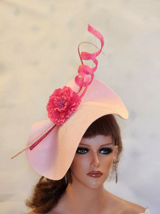 pink wide-brimmed hat with a pink flower and a pink ribbon.