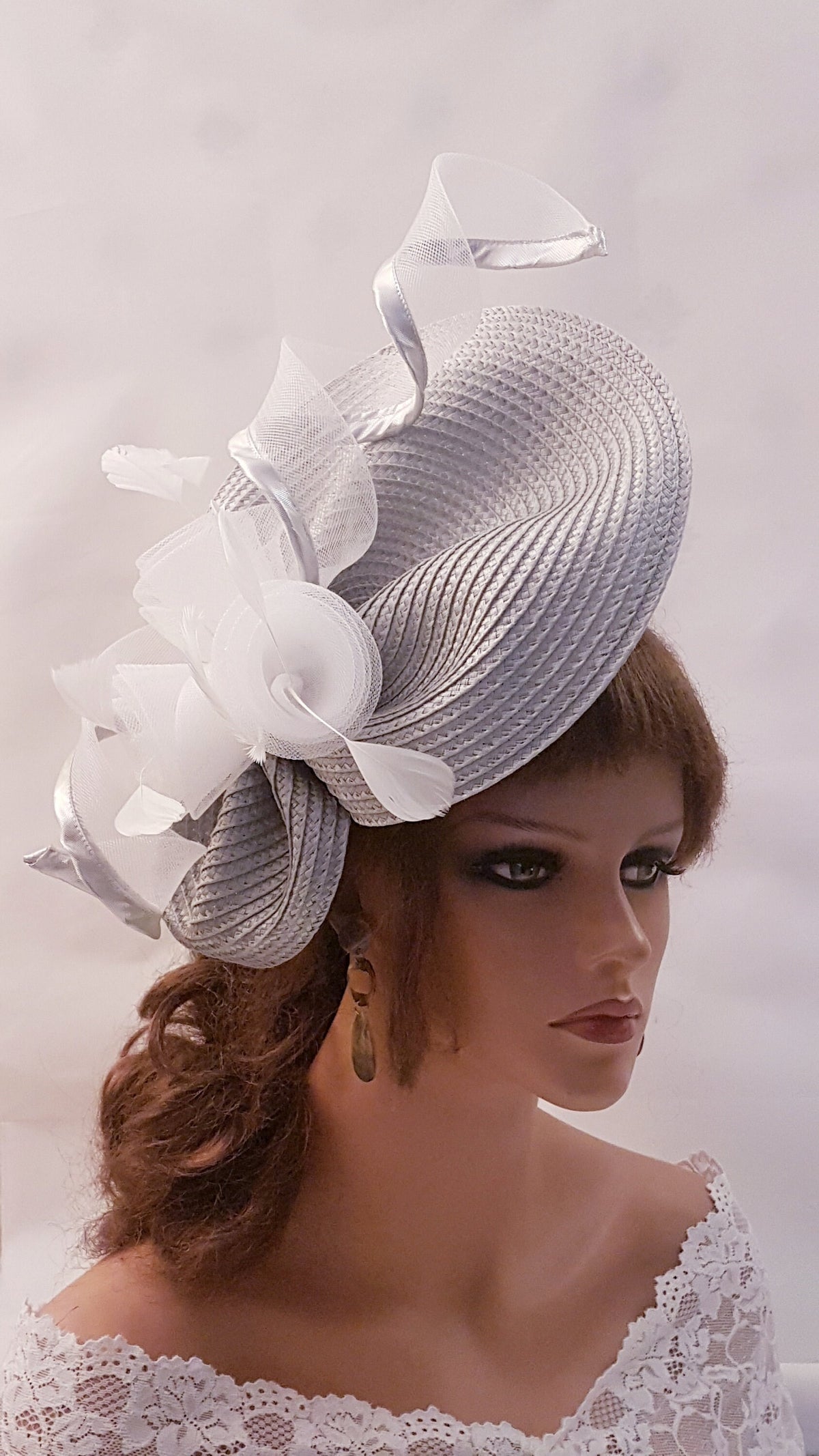 A silver and white Wedding hat fascinator