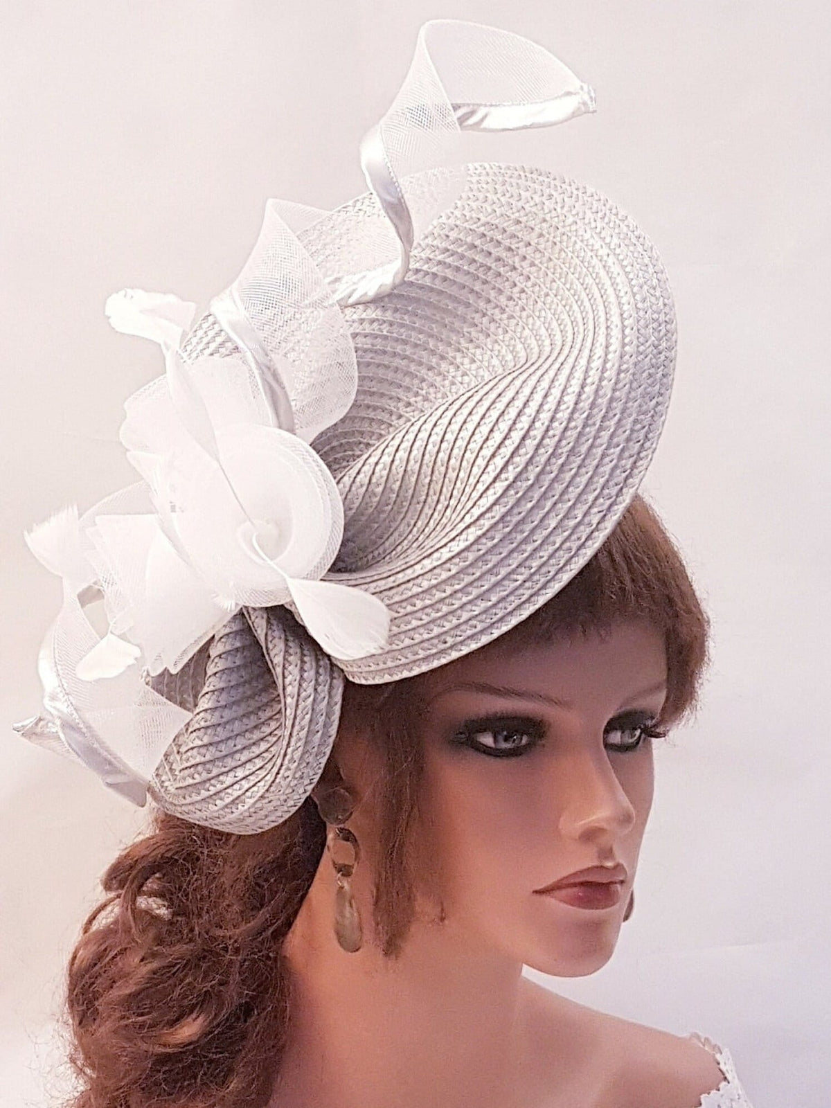 silver straw hat with a white flower and white ribbon detail.