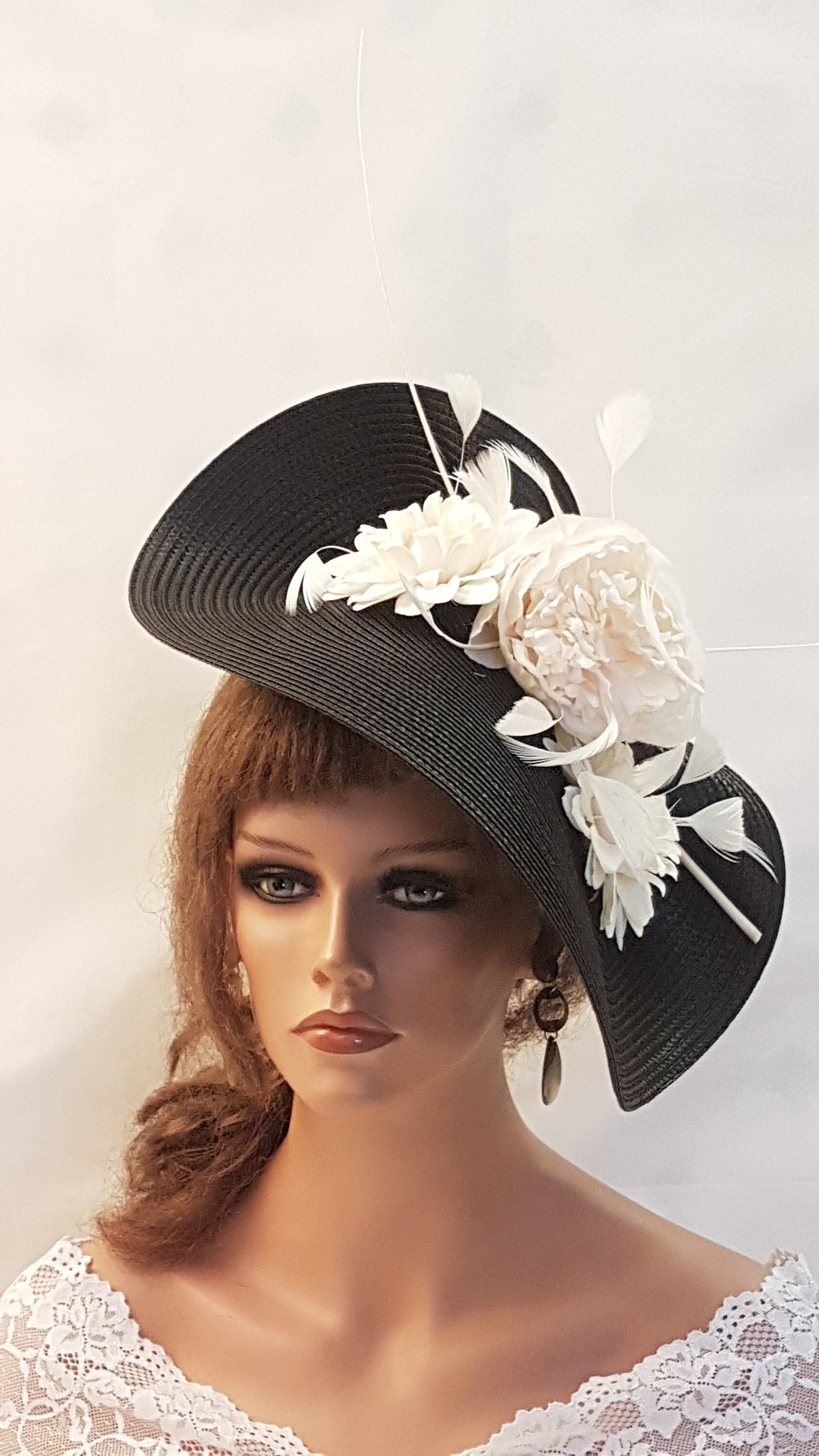 wedding fascinator. Black wide hat with white flower and feather embellishment.