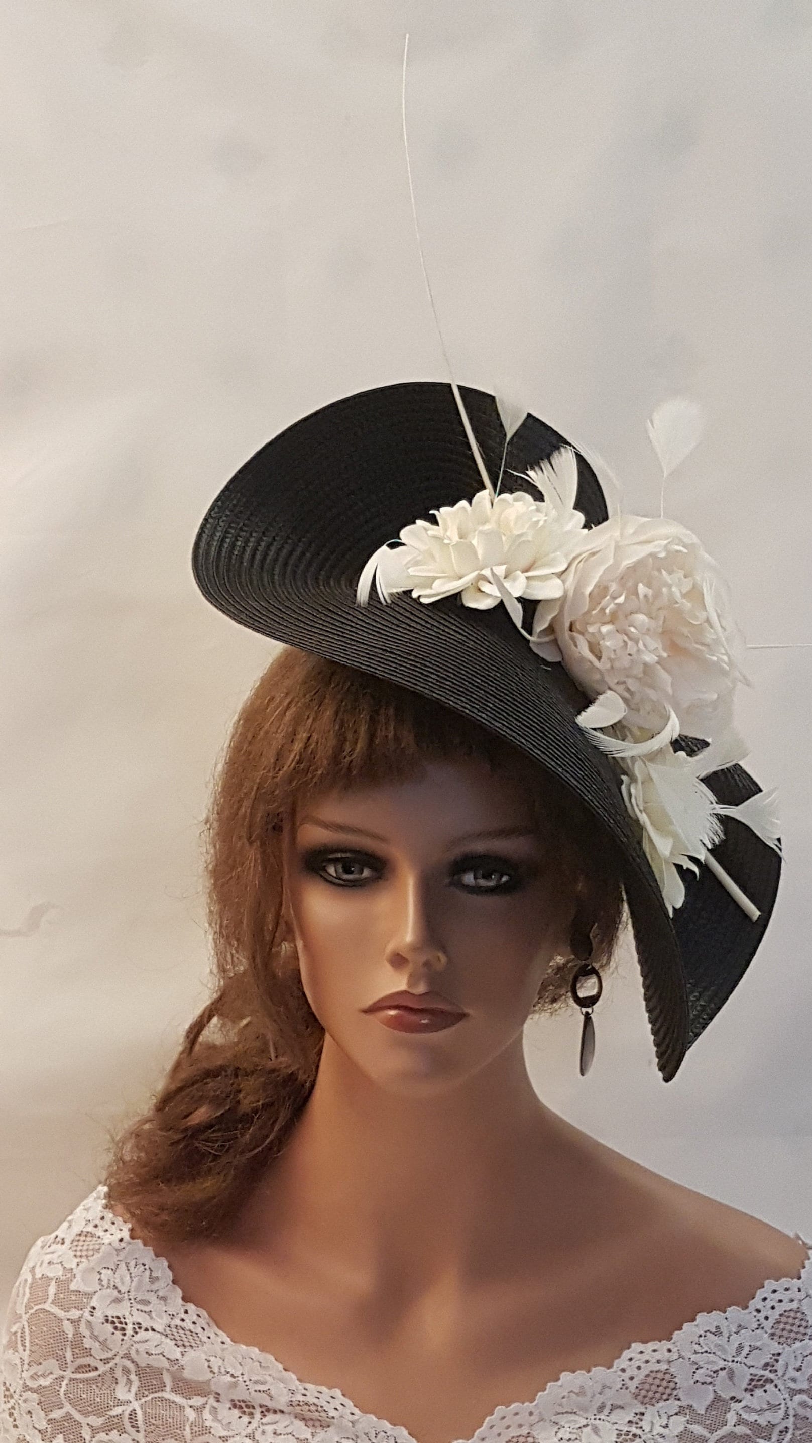 black and white  hat with a white flower and long quill feather for wedding and Ascot