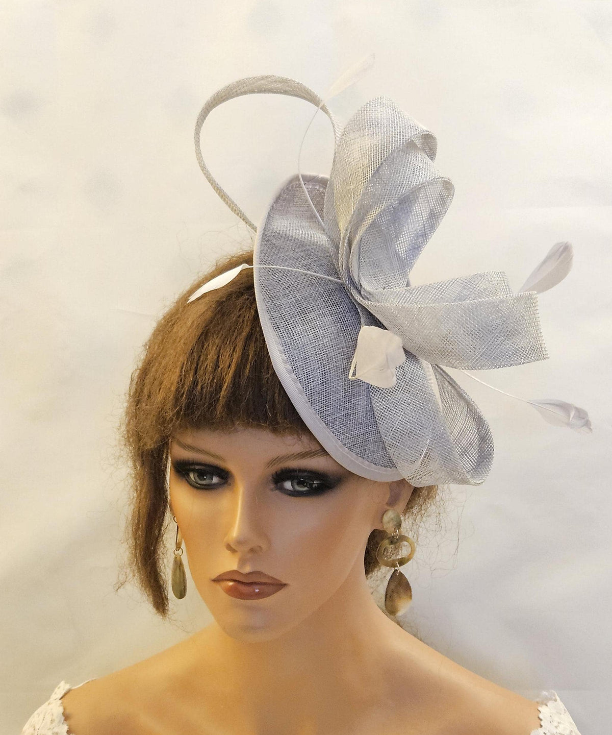 Silver grey Fascinator with sinamy loops and Feathers.