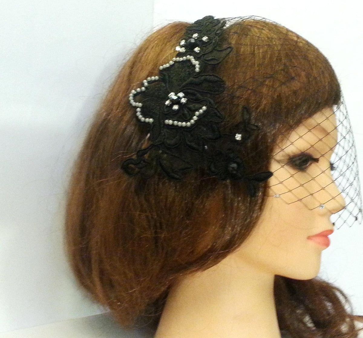Black birdcage veil with lace motif adornedwith grey pearls