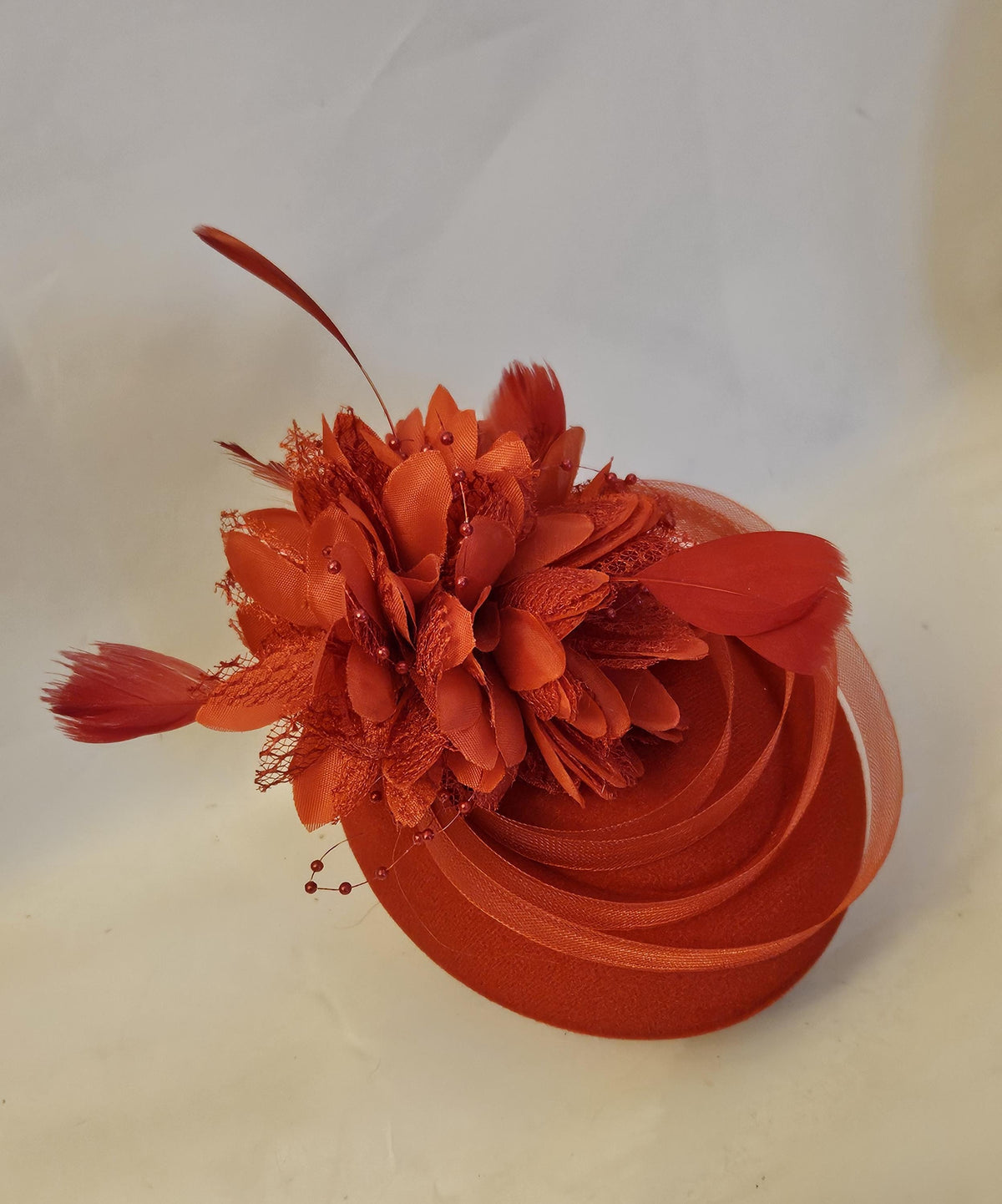 Red pillbox floral hat fascinatorwith feathers and crinoline loops for Race, Teaparties and wedding