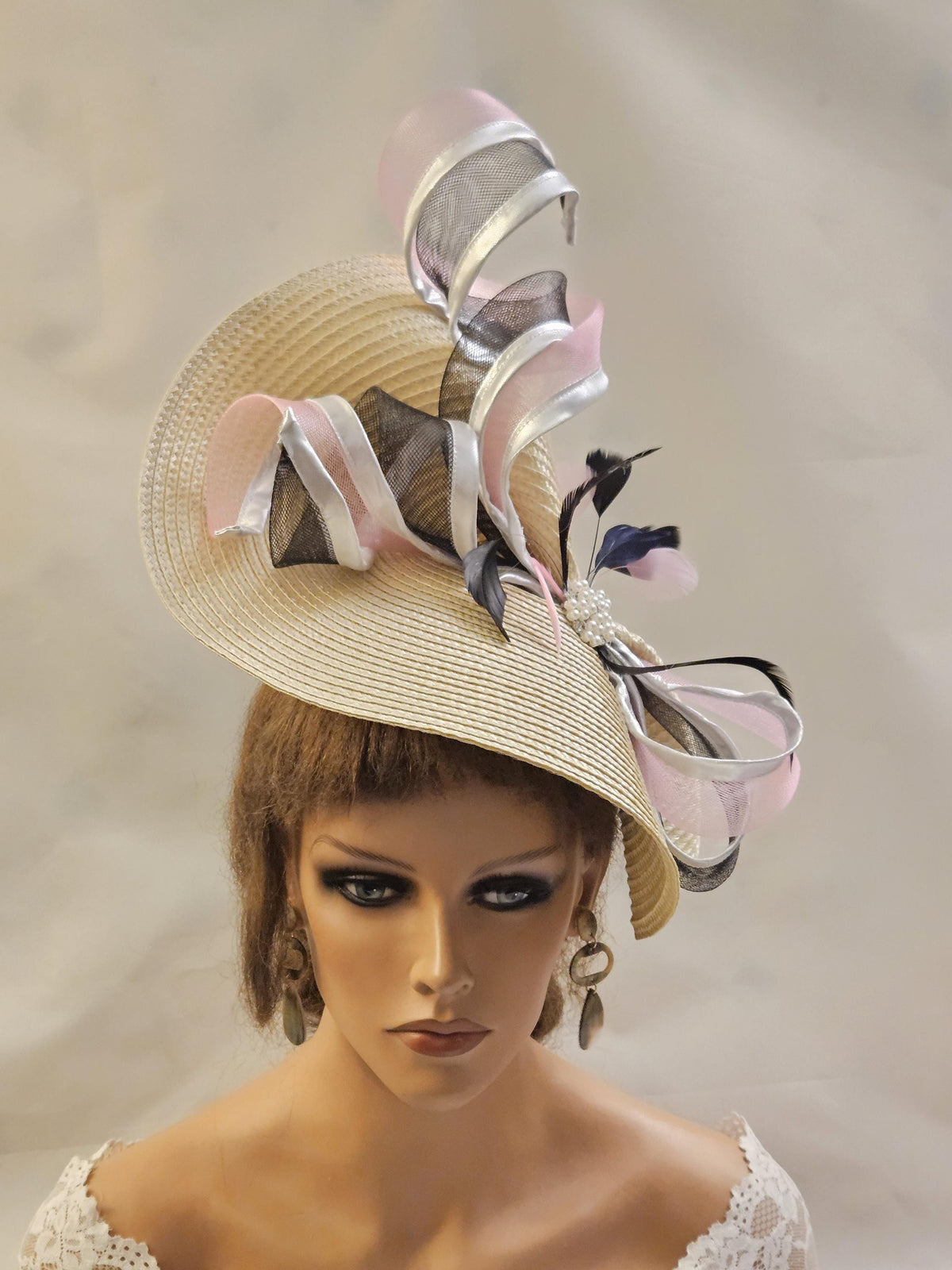 Beige Ascot hat fascinator with Black and Pink Swrils and feathers