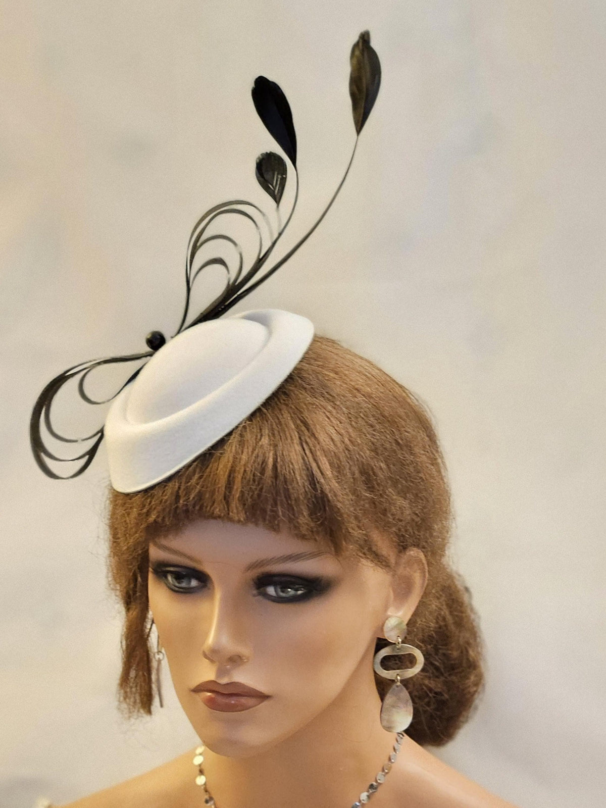 White pillbox hat fascinator with black feathers