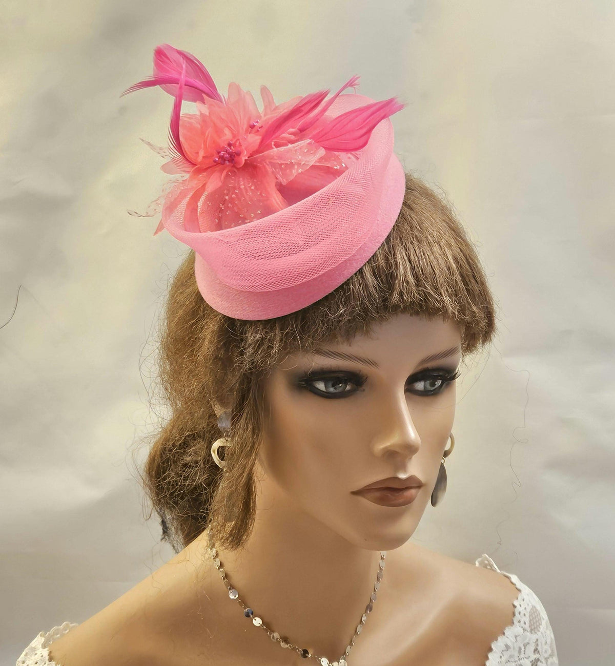 aHot pink fascinator for wedding and special occasions.