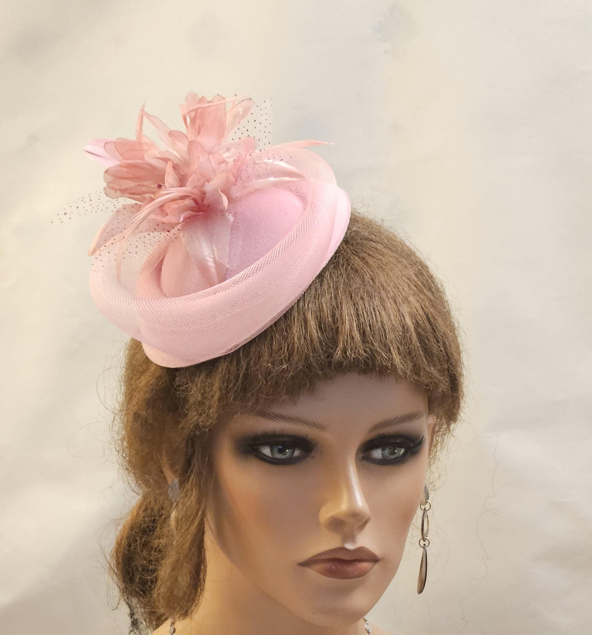 Pill box hat fascinator.