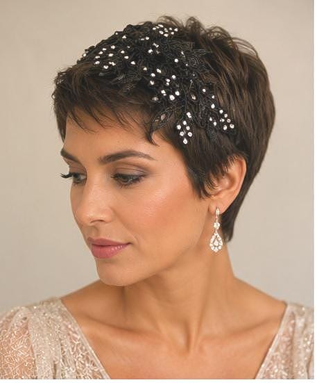 A black lace hair accessory featuring intricate floral patterns and embedded clear crystals.
