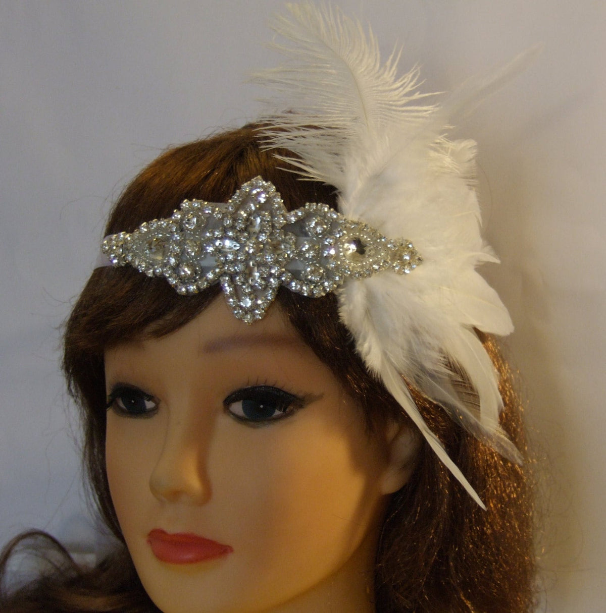 Gatsby feather headband with rhinestones feather accent.