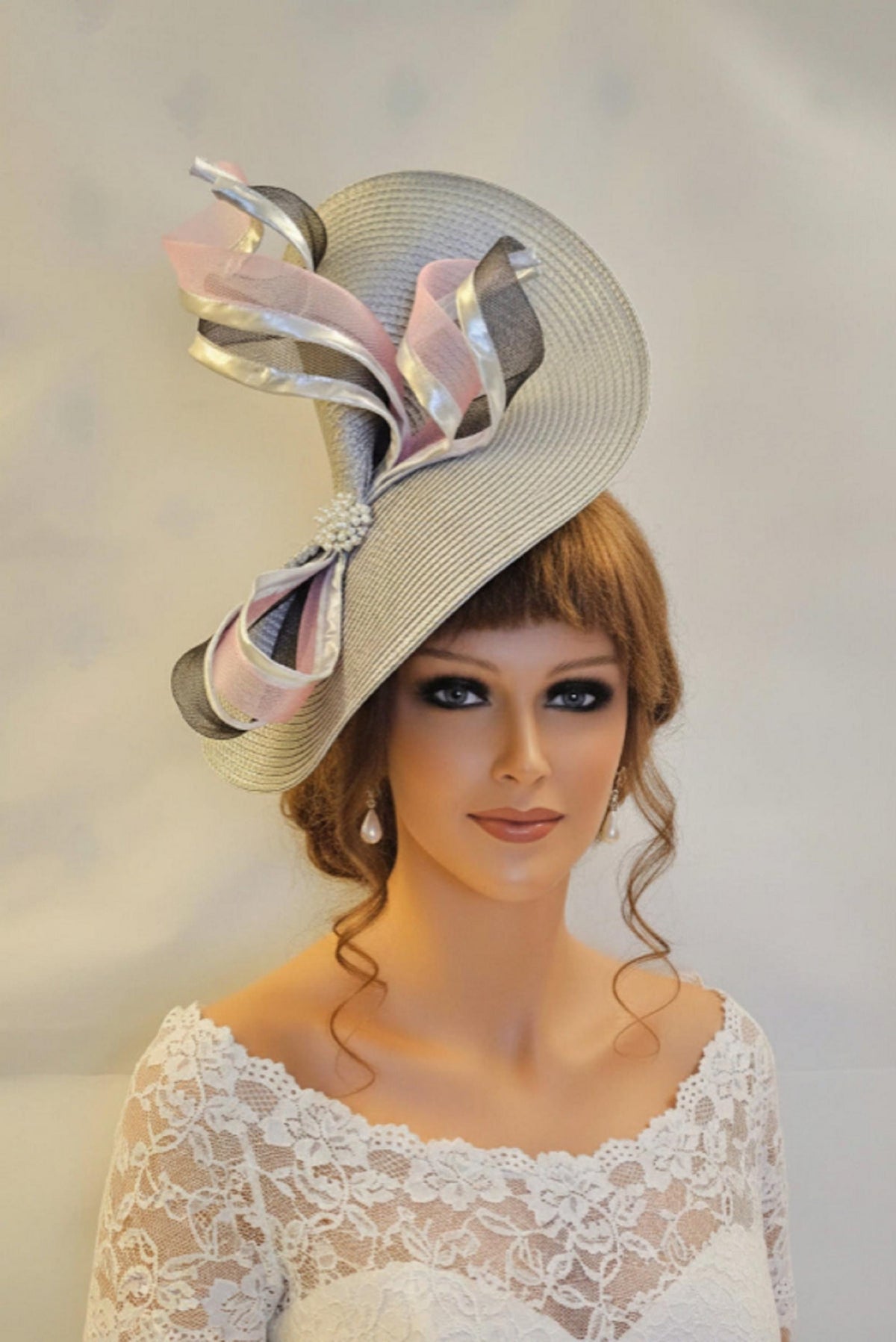 Silver grey fascinator for mother of the bride with pink and black swirl