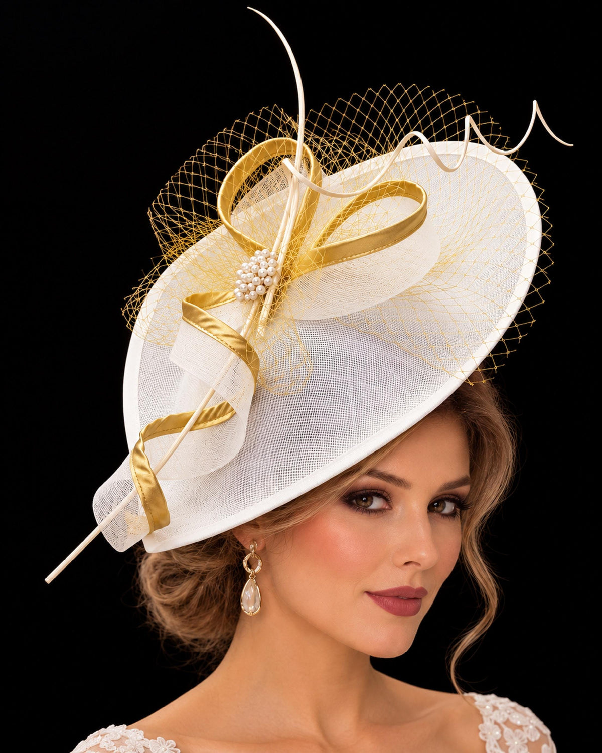 White fascinator hat with gold-edged loops, gold netting, pearl embellishment and decorative quills.