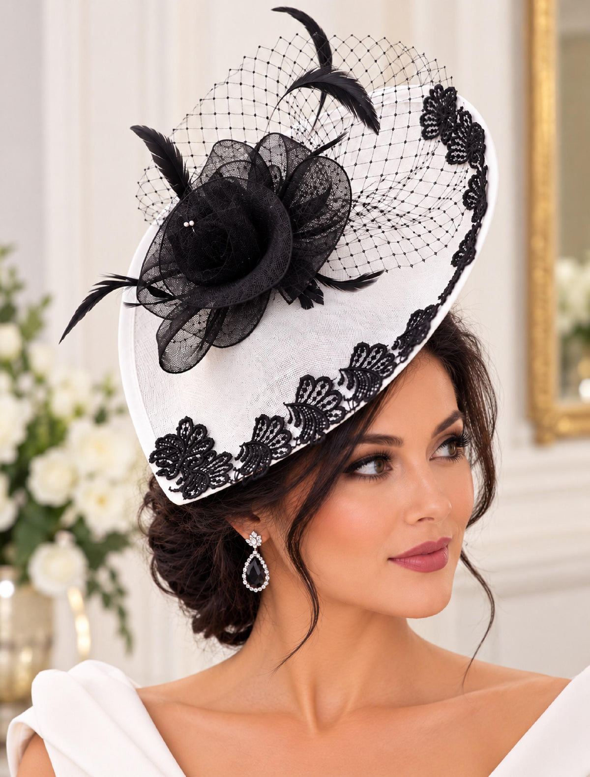 White fascinator hat with black lace trim, black flower, feathers and birdcage netting. Mother of the bride hat fascinator