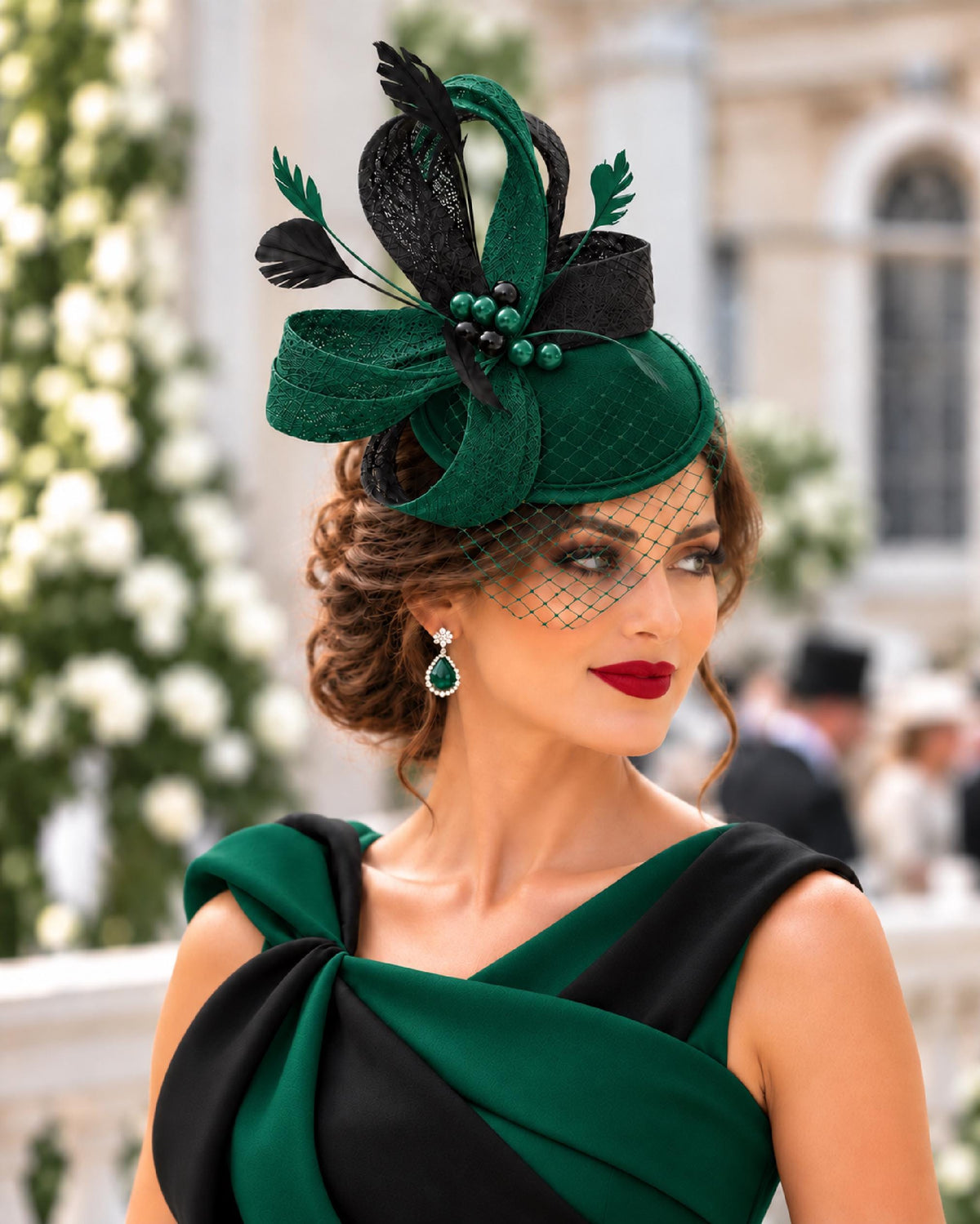 bottle green satin-base fascinator with green and black woven sinamay loops, feathers, pearl beads and an angled mini veil.